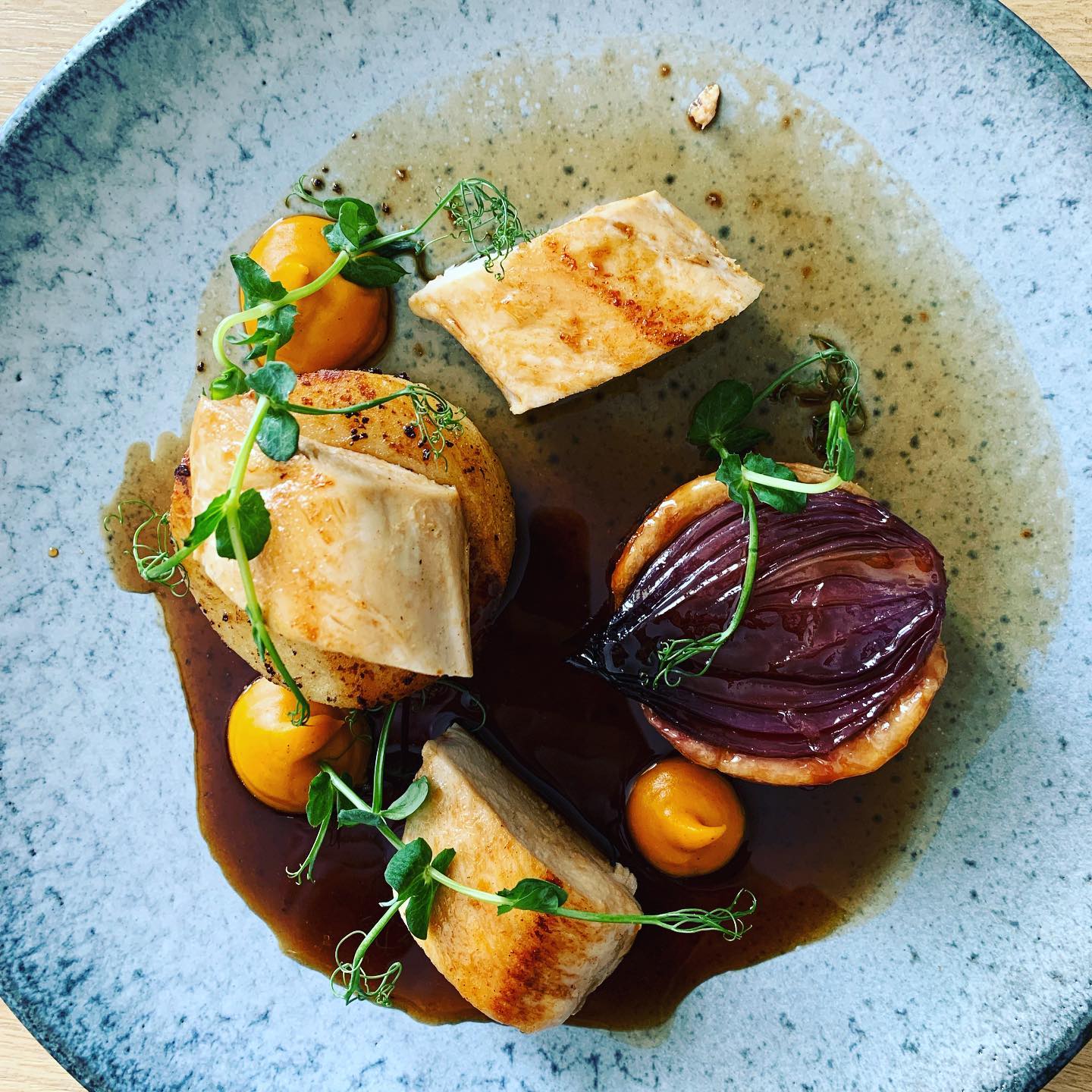 Seared scallops in a white plate