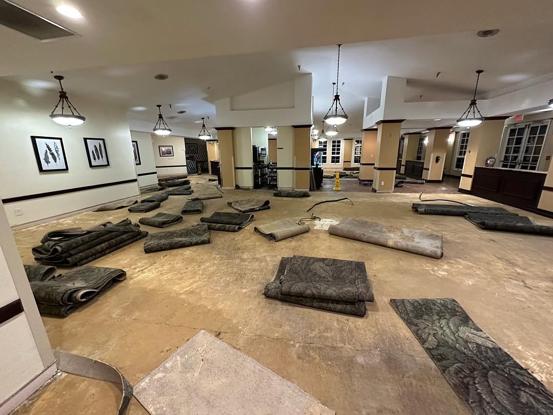 Old broadloom carpet rolled up and removed from a dining hall