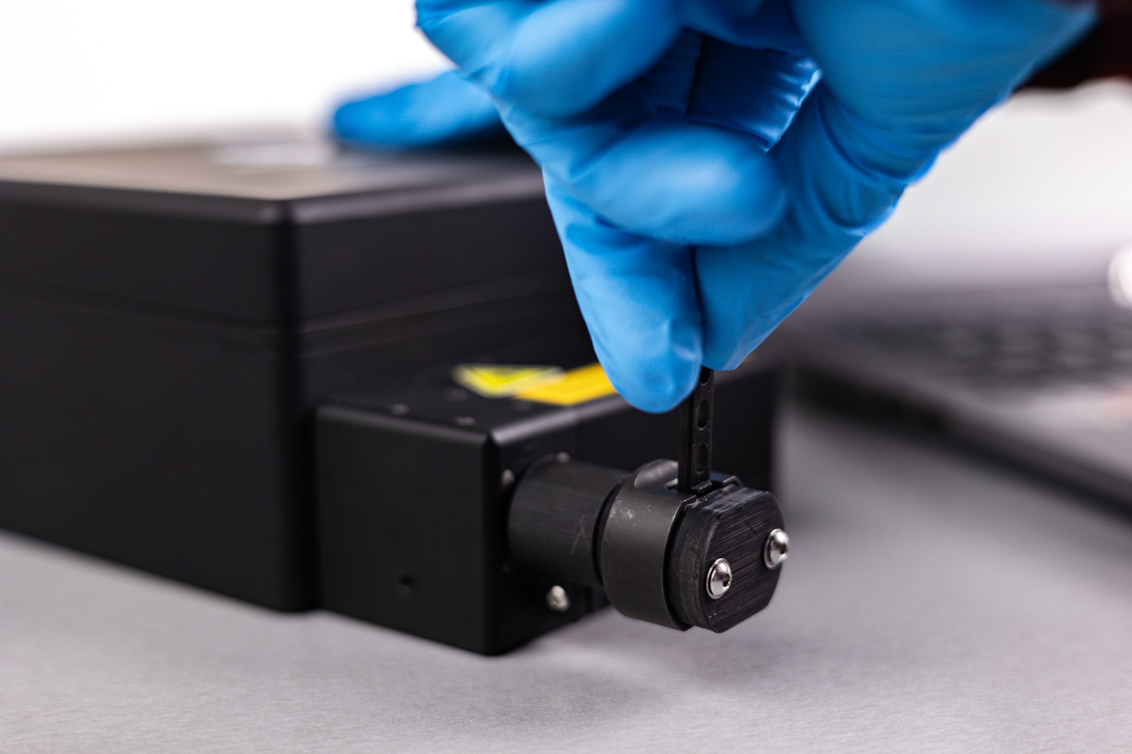 A prepared Test Kit cartridge being inserted into the Trace Scan attachment, to conduct a SERS/Trace Scan analysis.