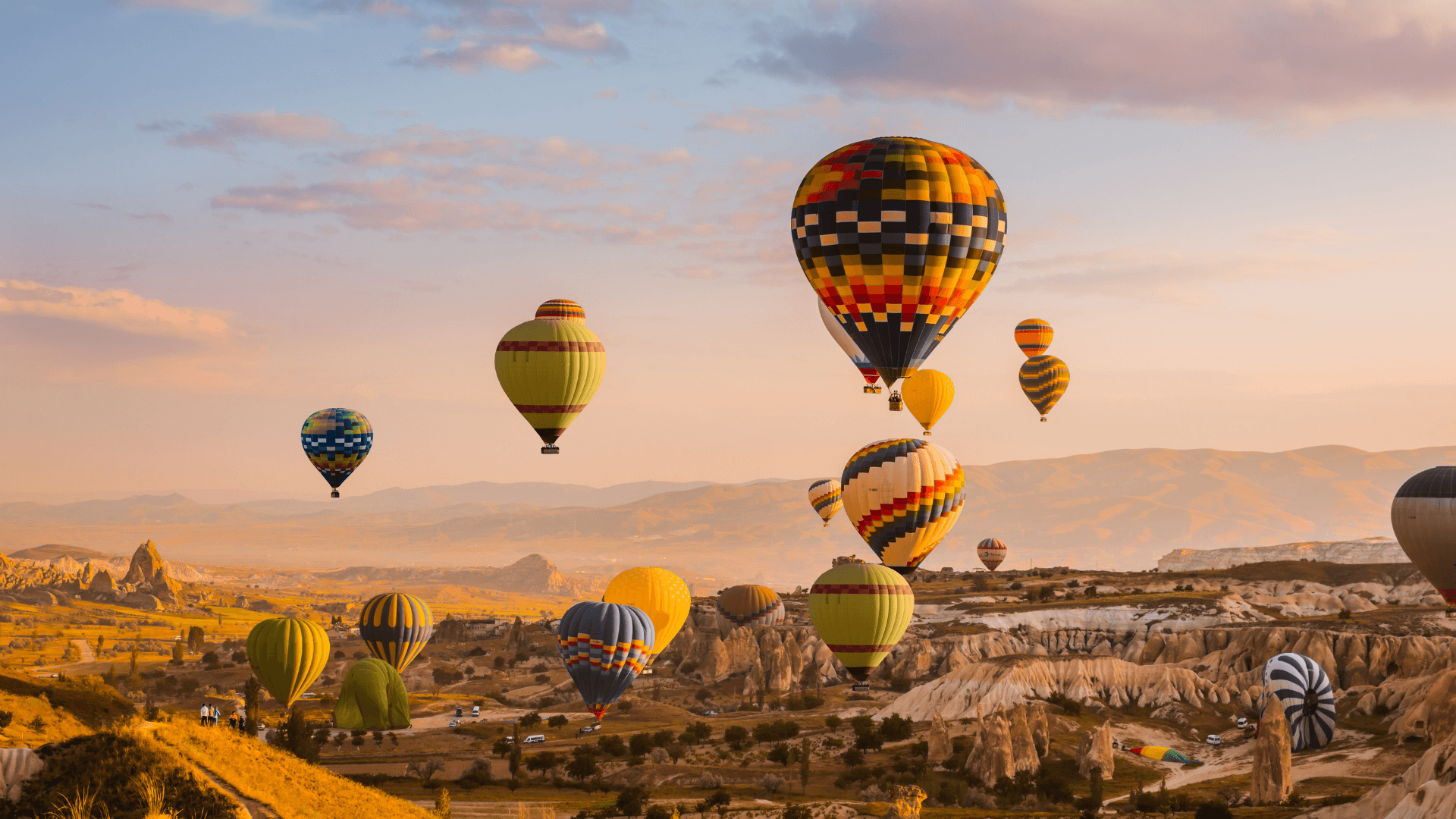 Cappadocia hot air balloons at sunrise, iconic landscape in Türkiye