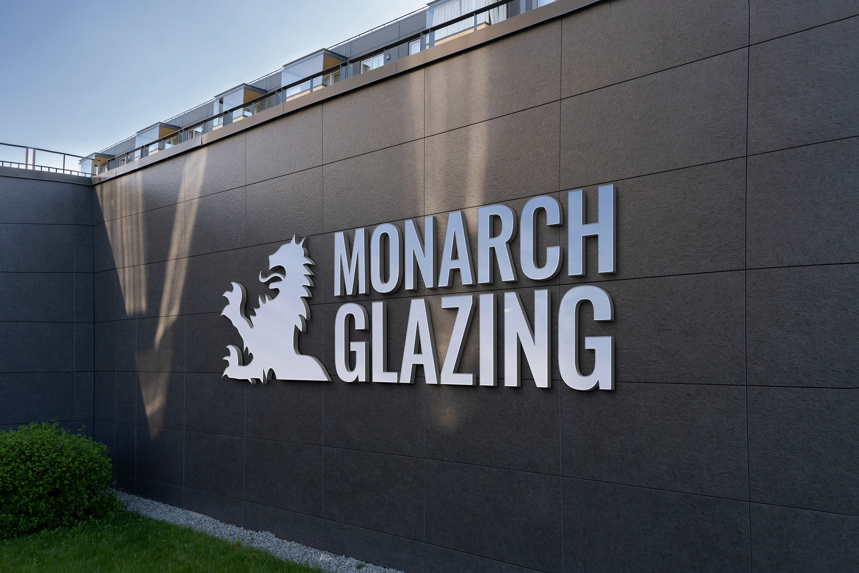 monarch logo in aluminum signage on wall