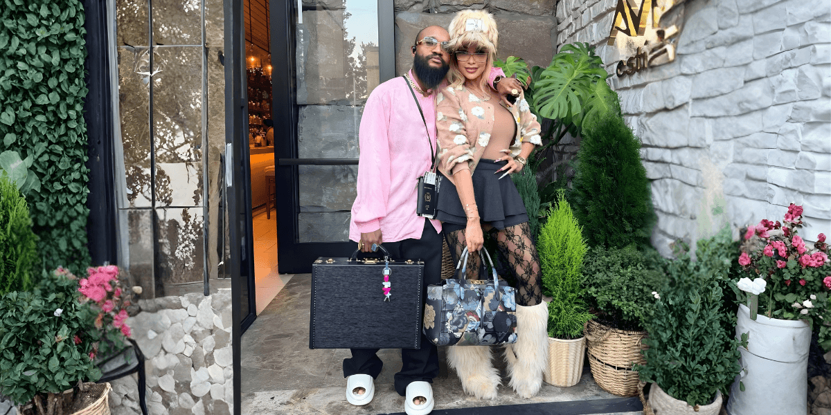 VELOSOSTYLE and collaborator pose outside a stylish venue, showcasing a fusion of haute couture and street style.