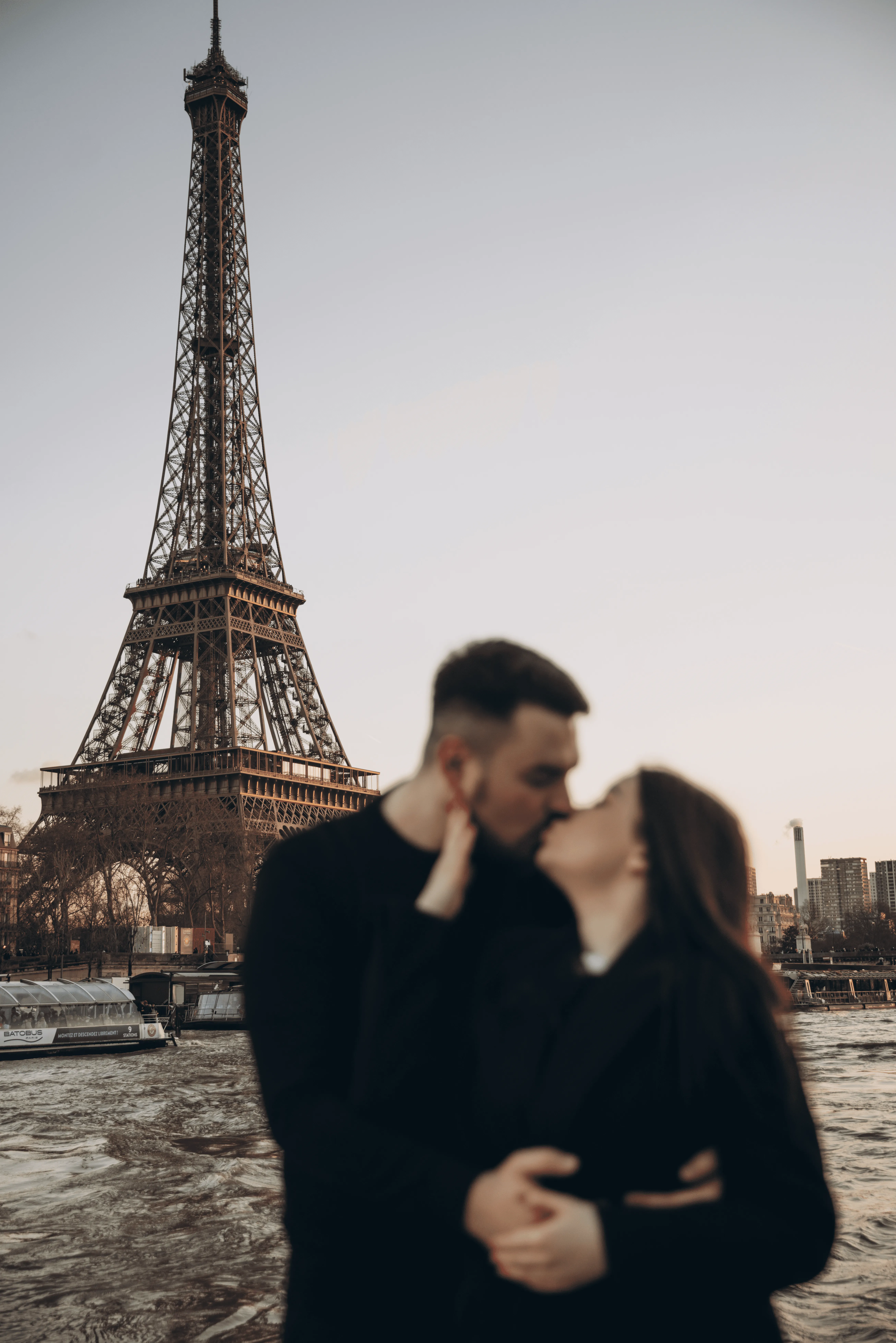 A couple stands closely in an intimate embrace.