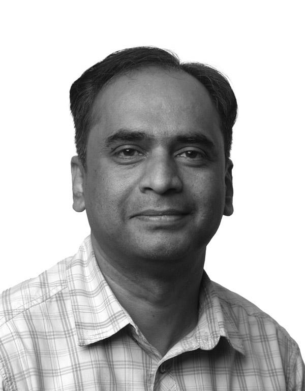 A person stands in a sandstone cave.