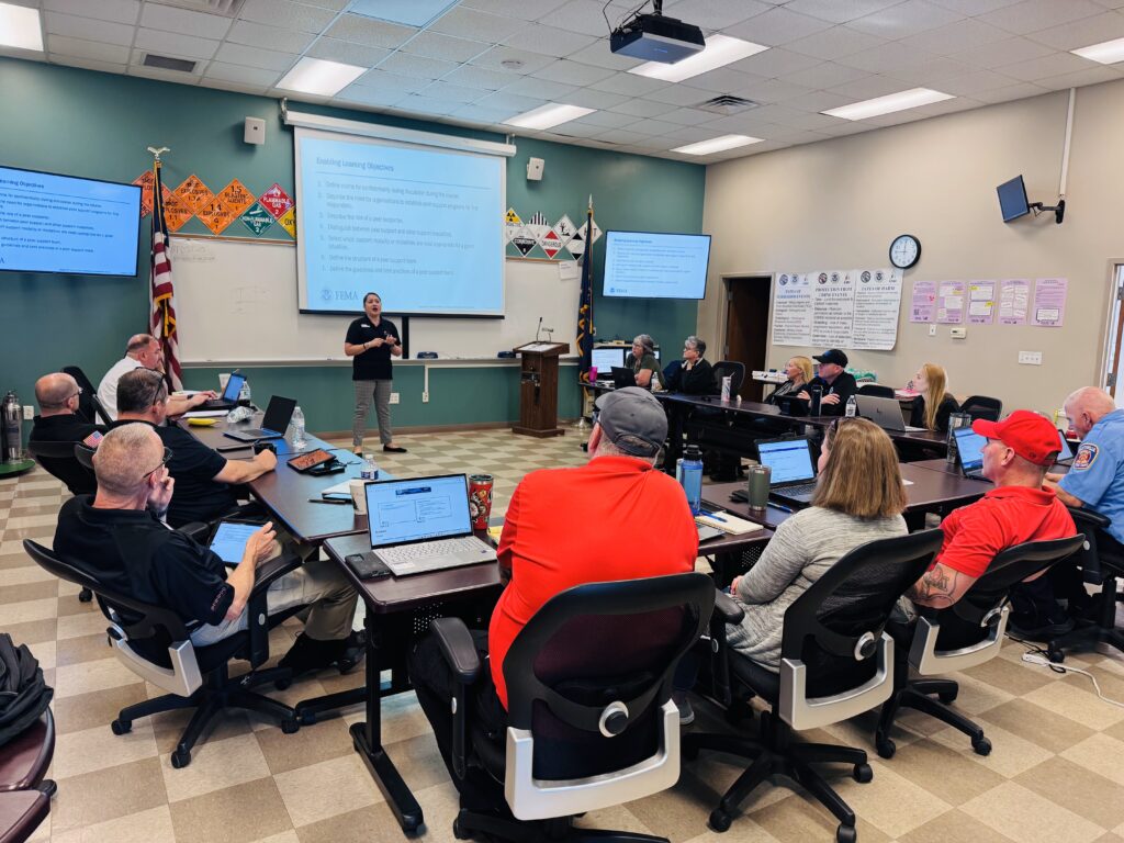 people sitting in a classroom listening to a speaker