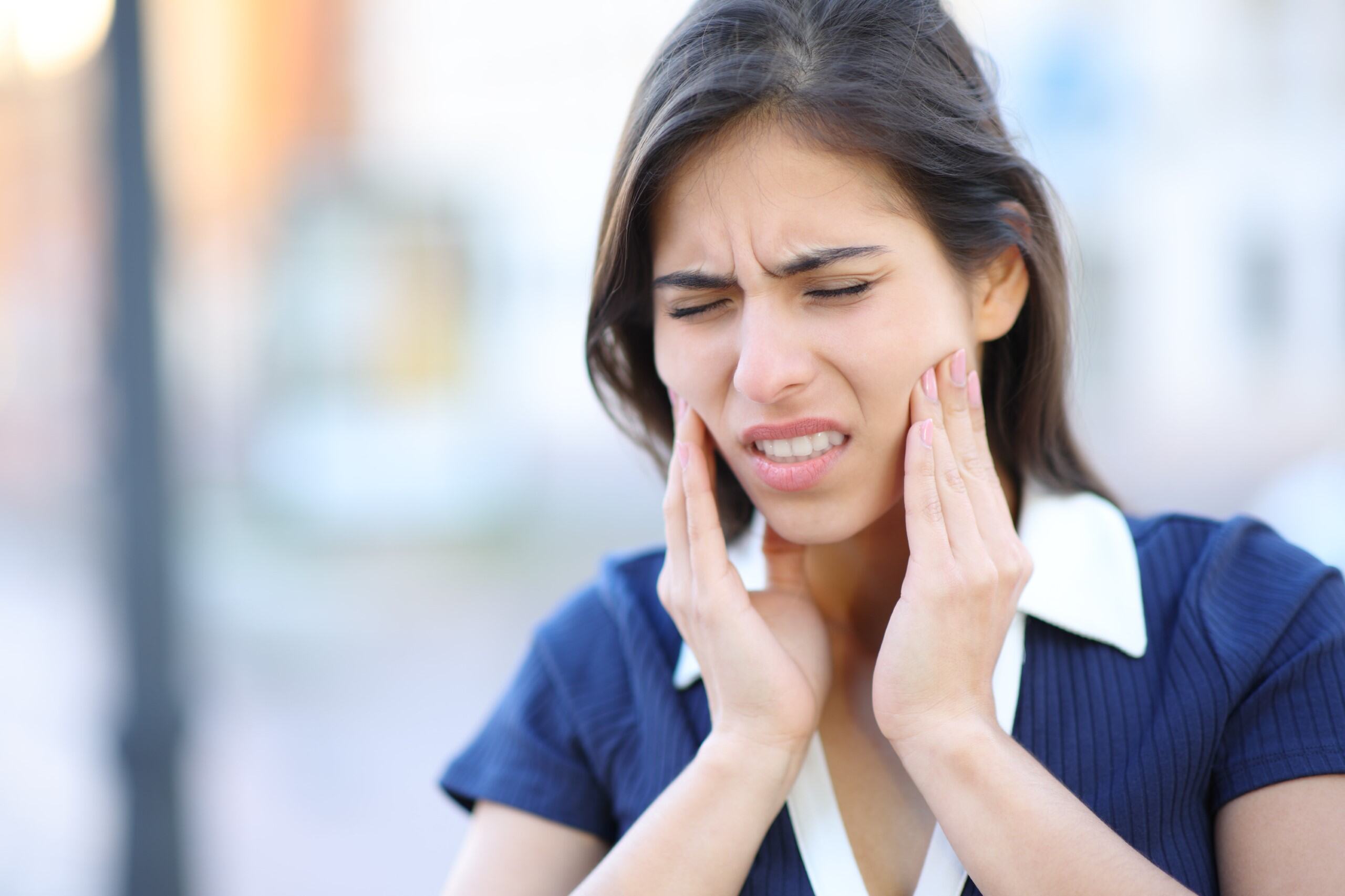 woman in blue long sleeve shirt covering her face with her hair