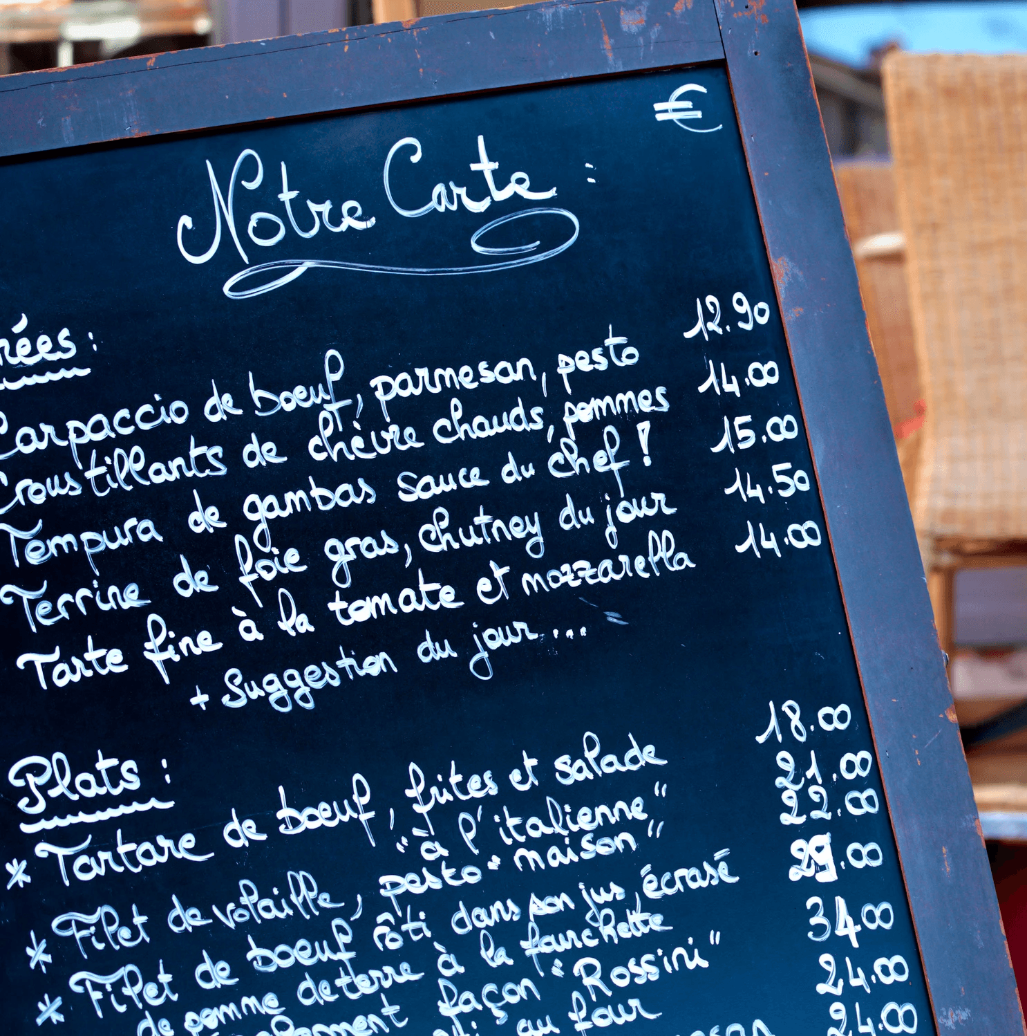 French restaurant menu board showing seafood dishes and prices