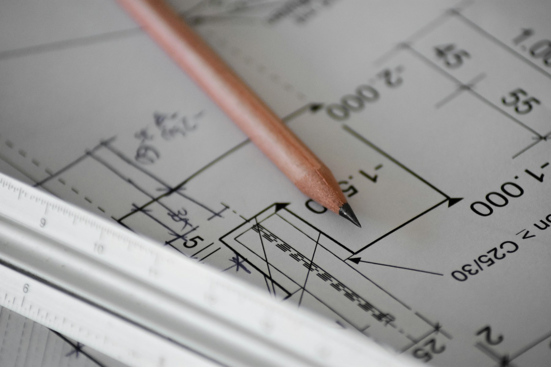 Pencil resting on architectural drawings
