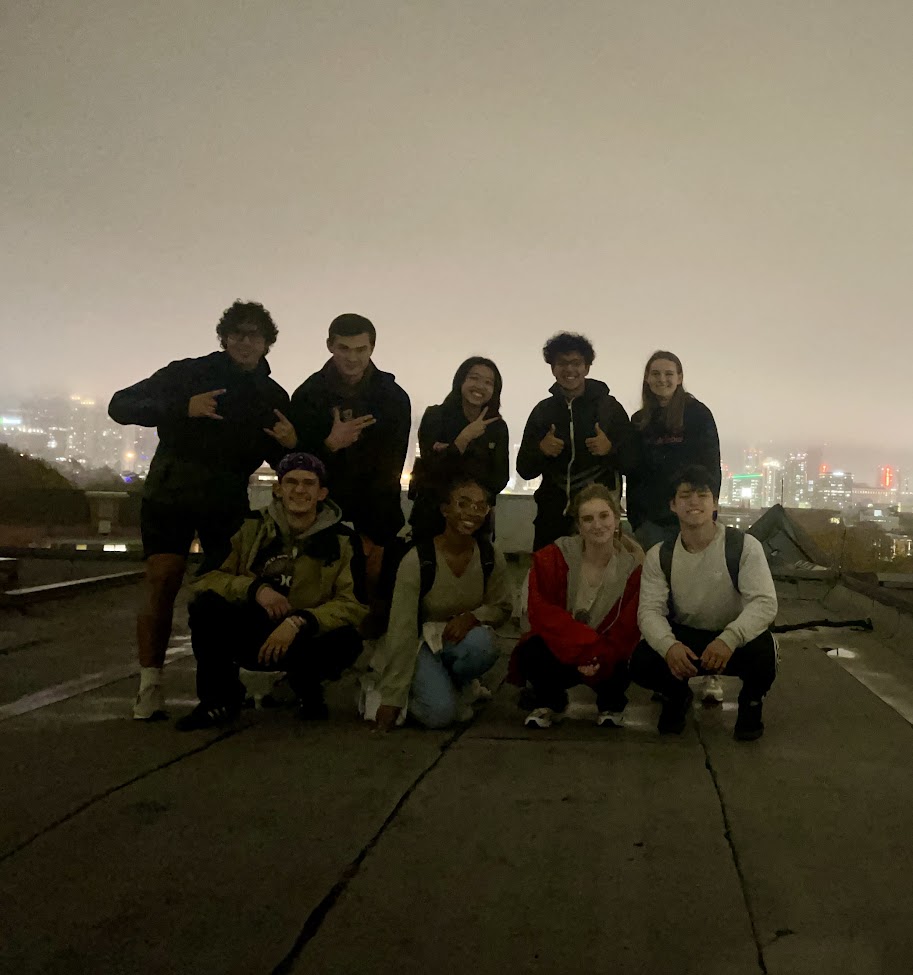 Family wearing traditional attire with lanterns, father holding a daughter up.