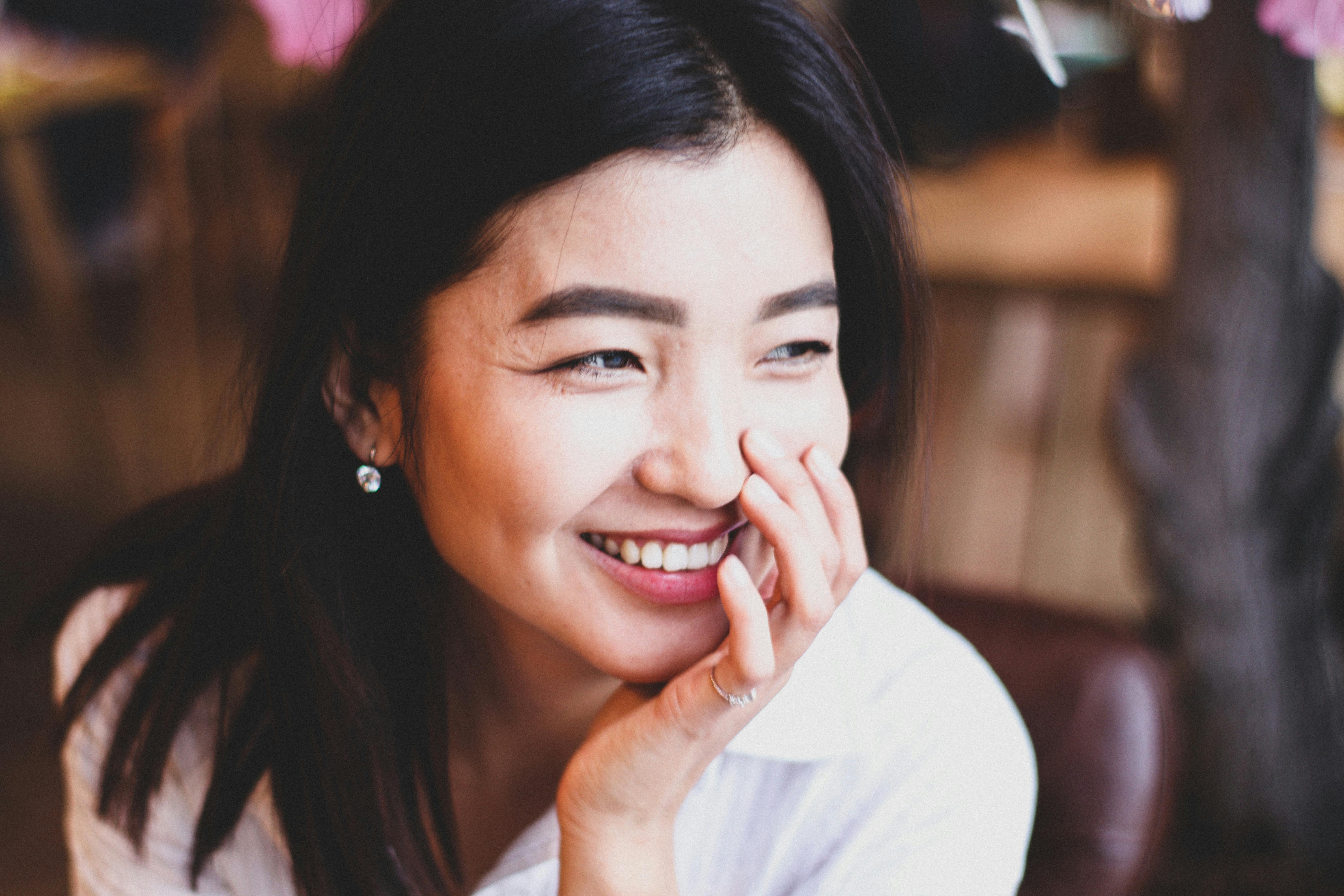 person taking photo of white feather
