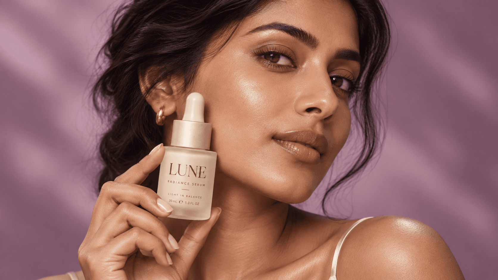 A woman holding a LUNE skincare bottle