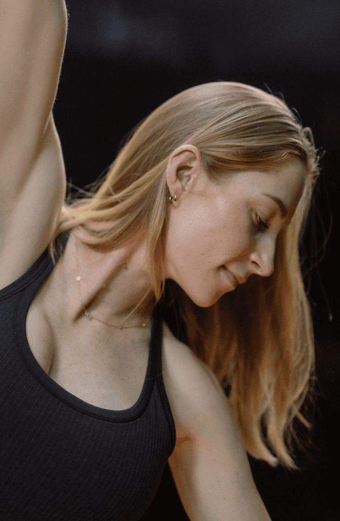 Black cosmetic product bottle against a dark background