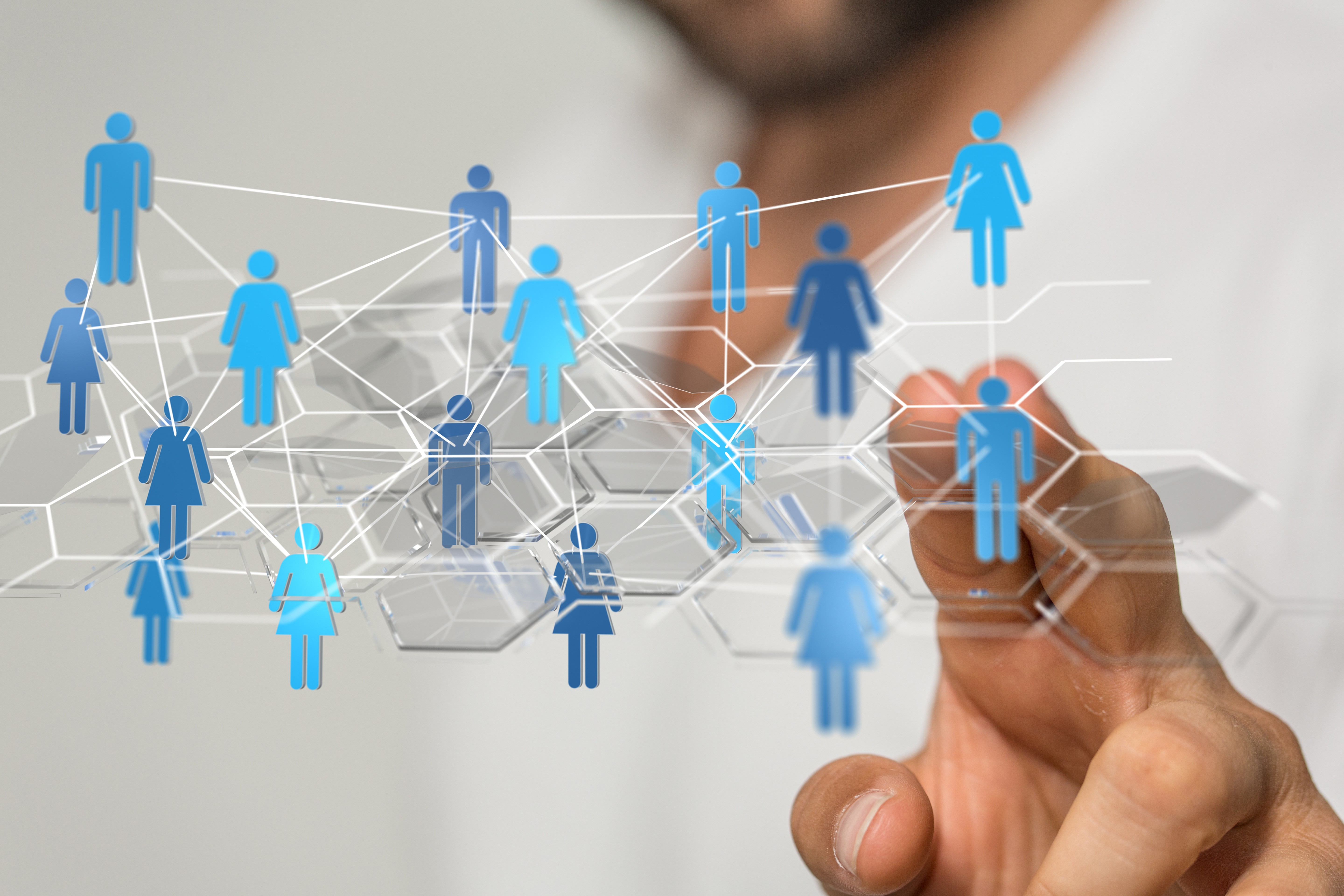 image of person touching a screen with human icons mapped together through data analytics points