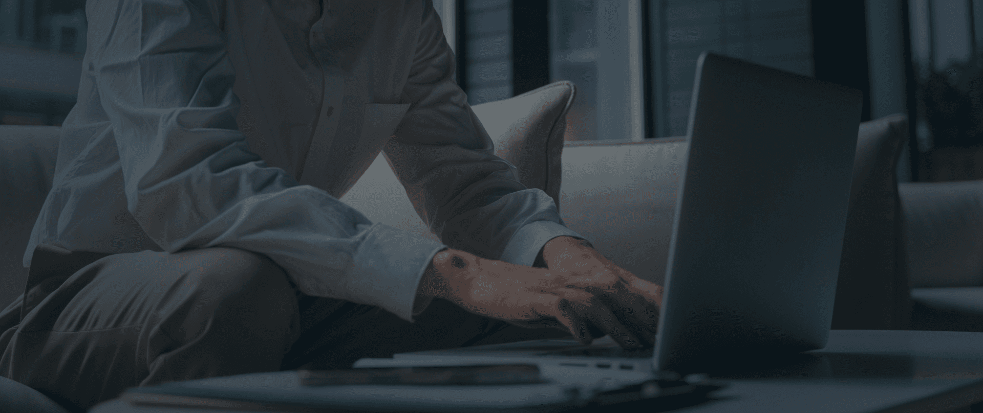 A man types on a laptop