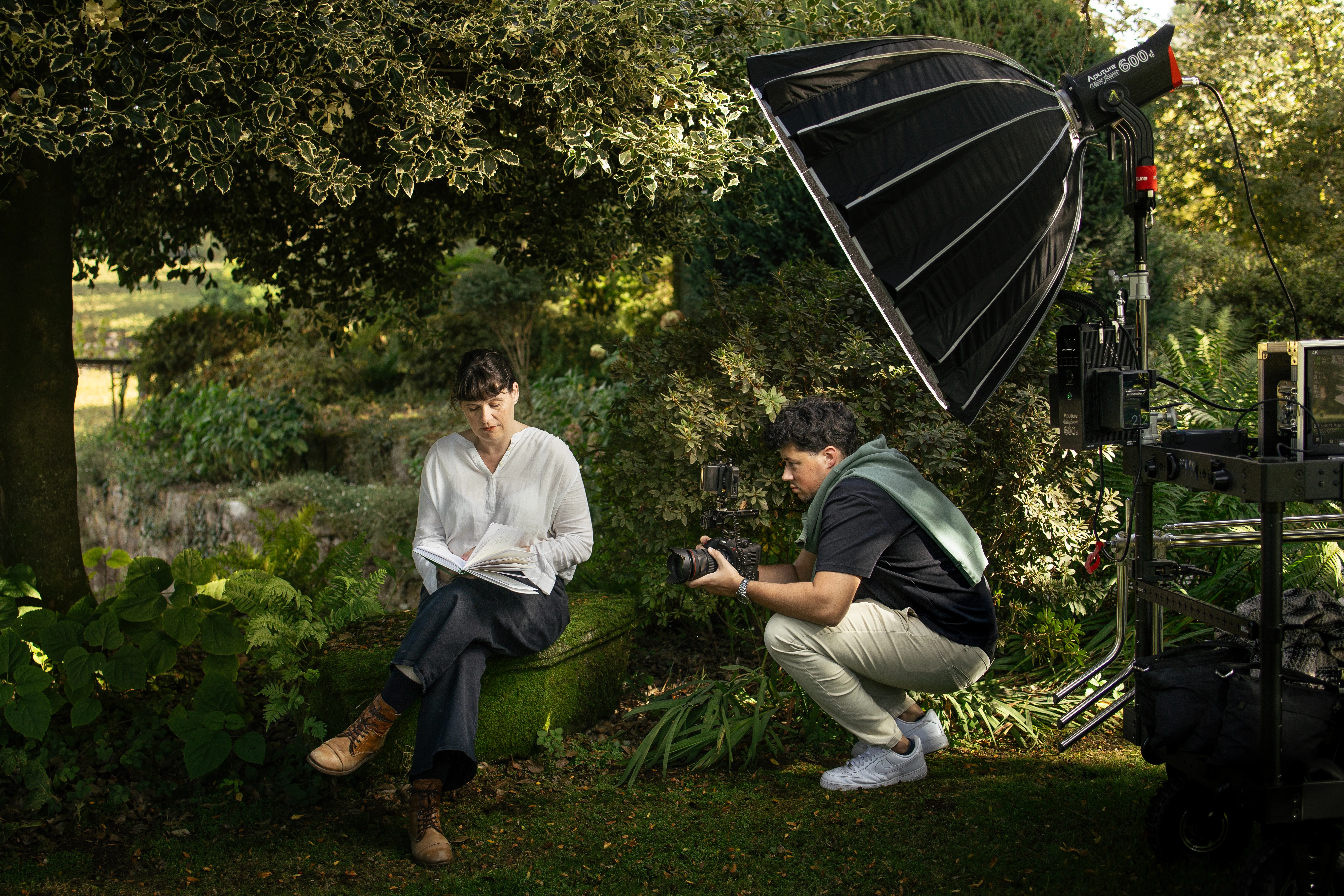 Close-up of hands holding a green crocheted handbag with a silver clasp.
