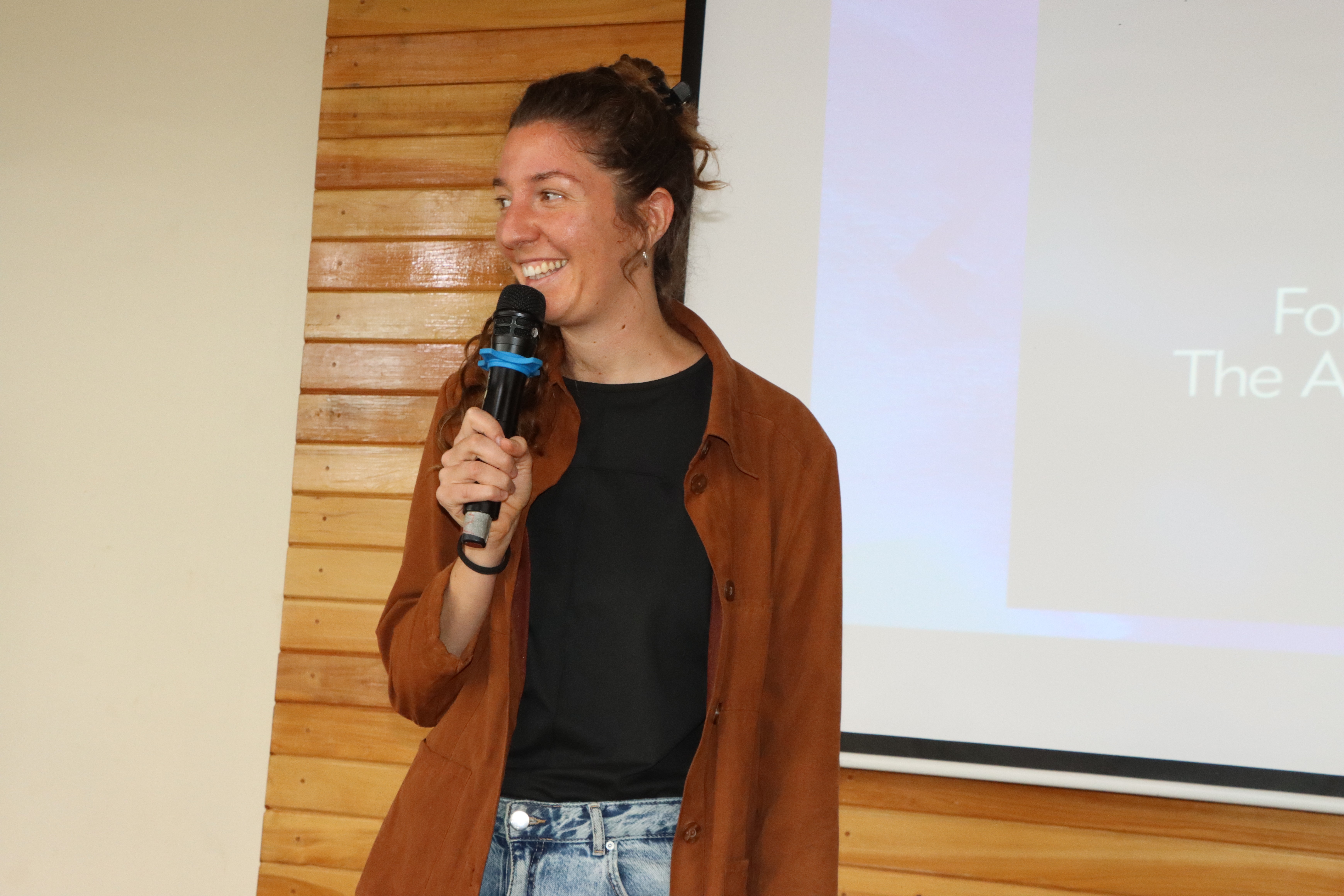 Close-up of a dark green leaf showing its textured surface and central vein against a muted background.