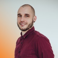 woman staring directly at camera near pink wall