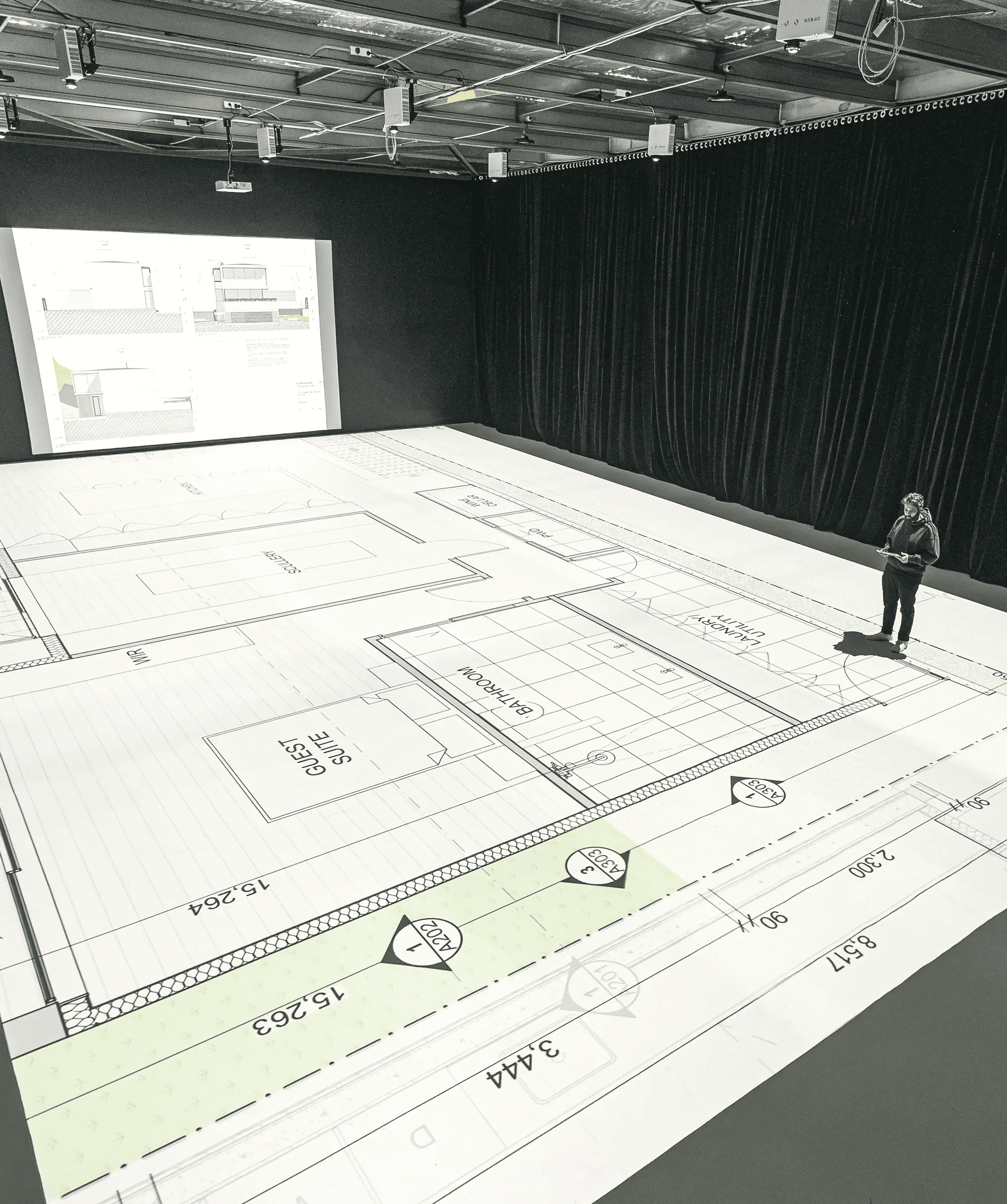 wide angle view of the studio with floorplans being projected
