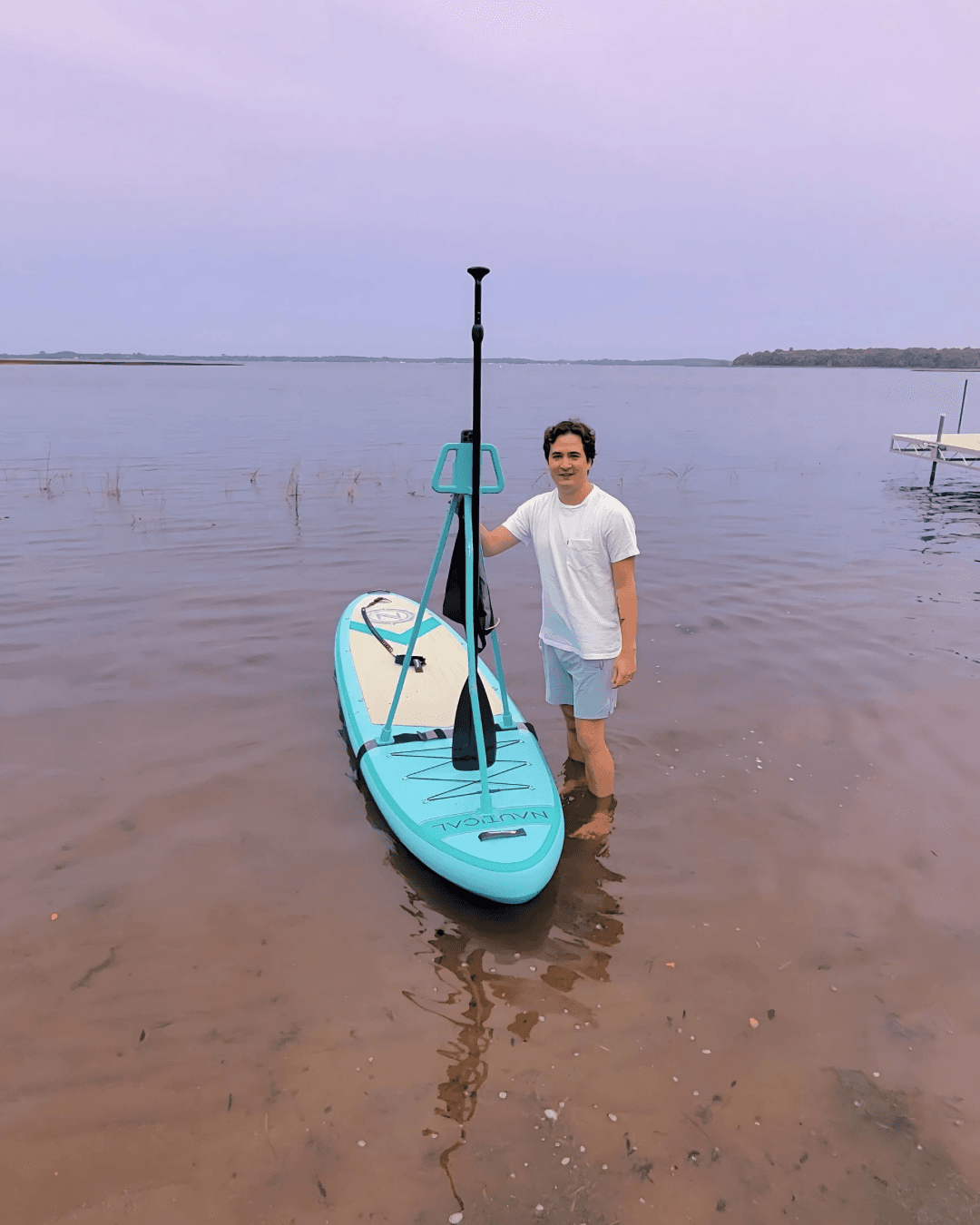 A woman on a paddleboard with her paddle partner