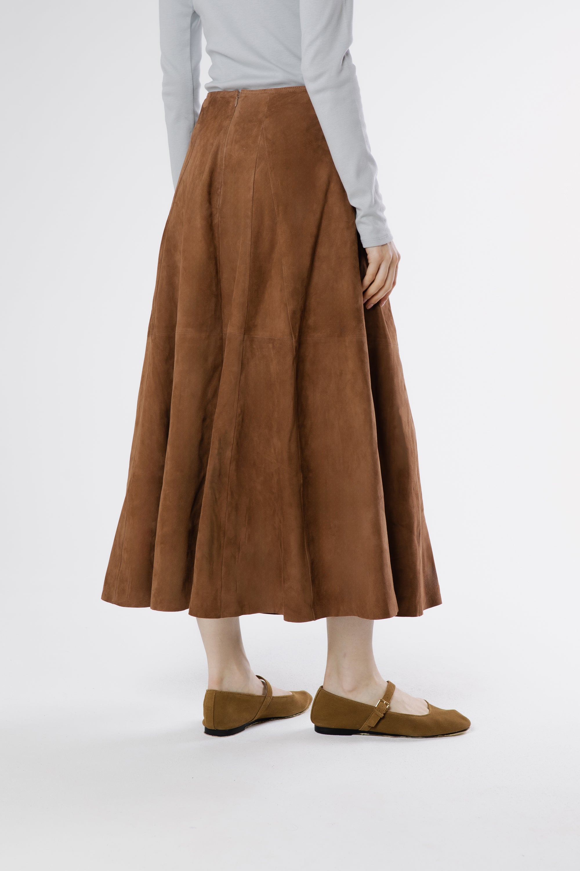 Back view of moca suede midi skirt showing fluid panel structure