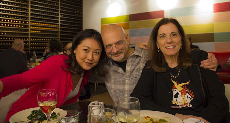 A photo of a group of people siting at a table in a restaurant.