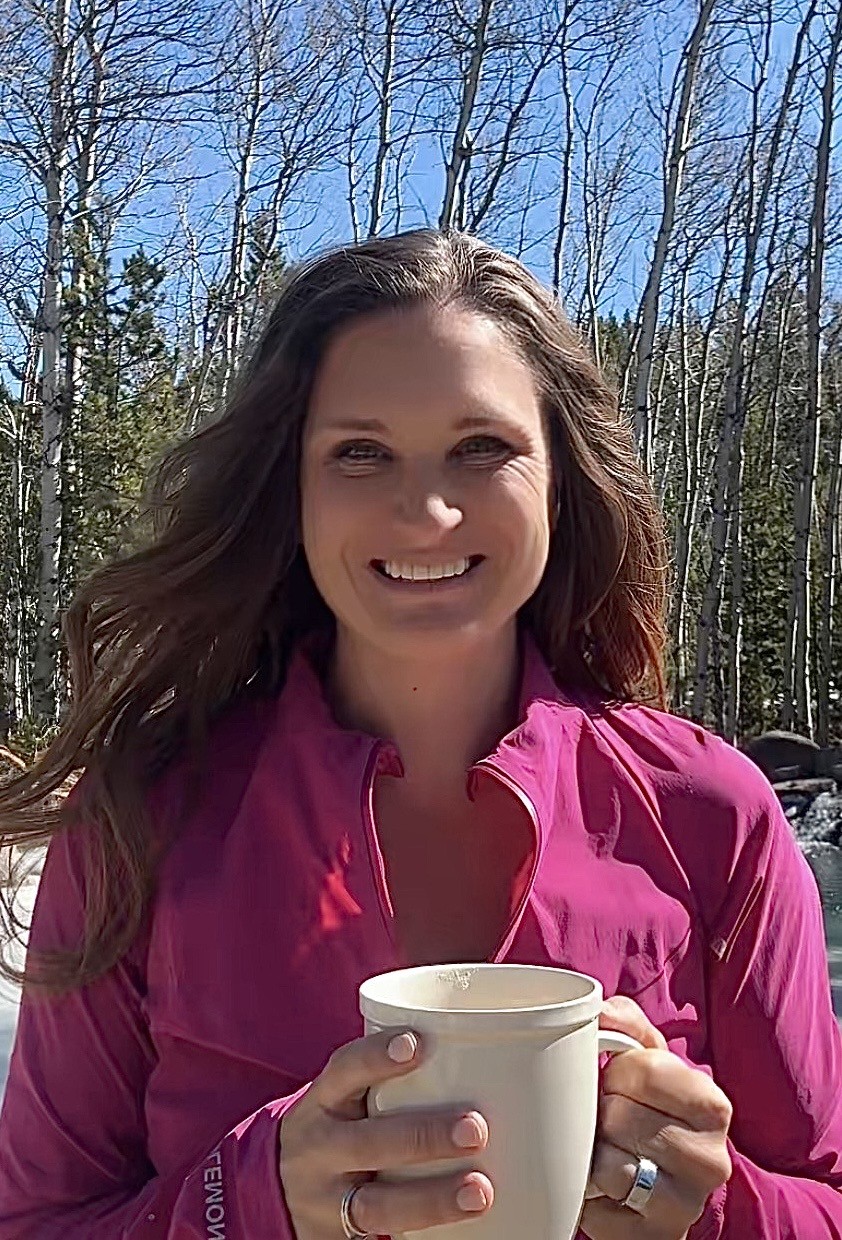 Anne holding a mug of coffee outside