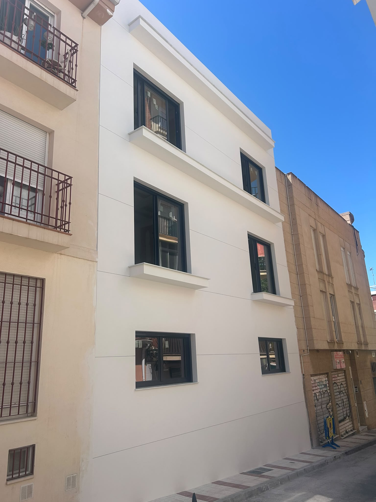 Construction site excavation at Calle Rodríguez 7, Málaga — groundworks and demolition phase of new-build boutique apartment building in the city centre