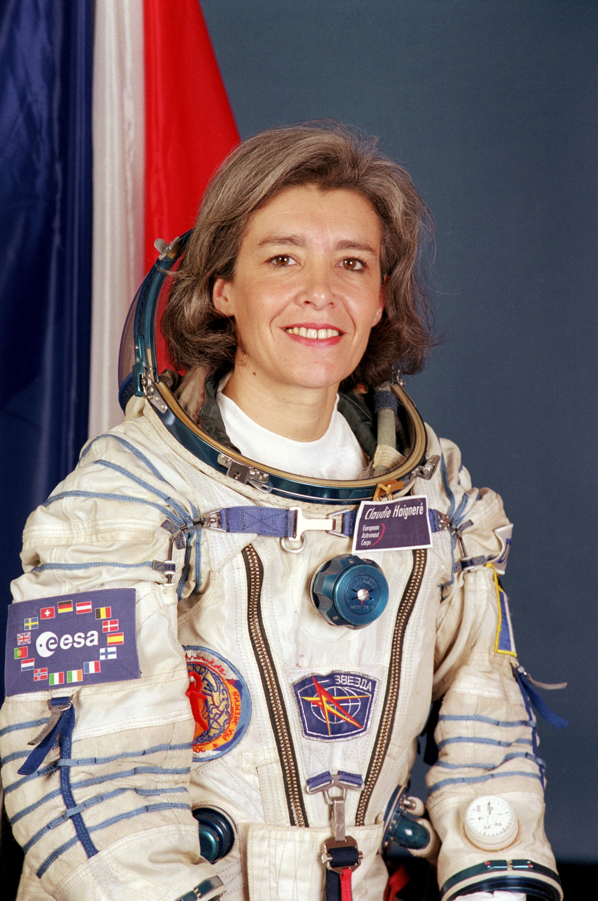 muscular man in glasses smiling and folding arms