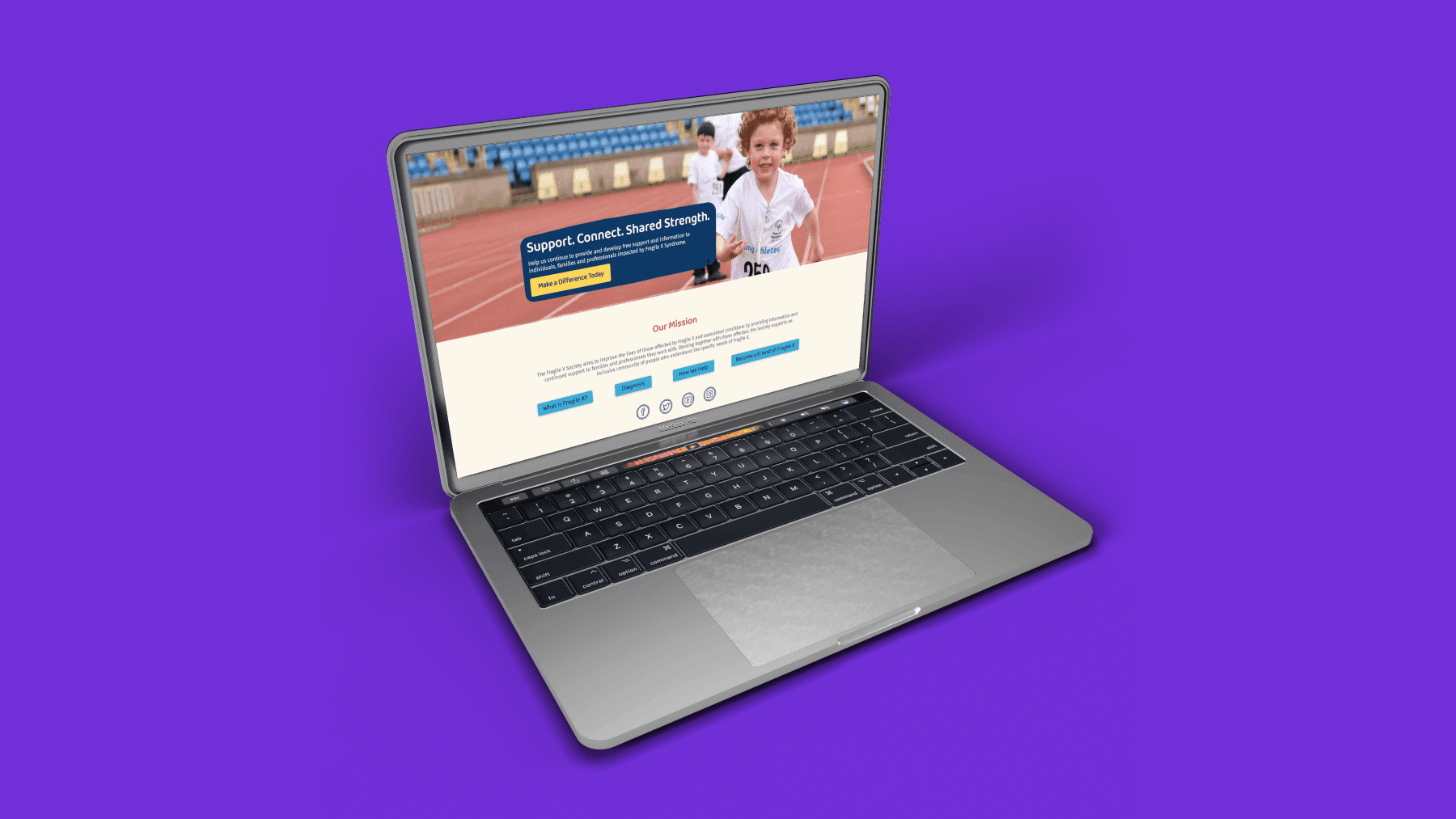 The Fragile X Society updated website landing page on laptop on purple background