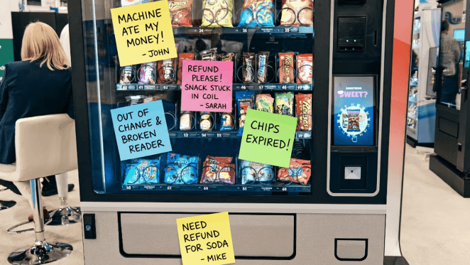 A comic book style illustration of a half-soda machine half-shark chases people who are fleeing down a beach