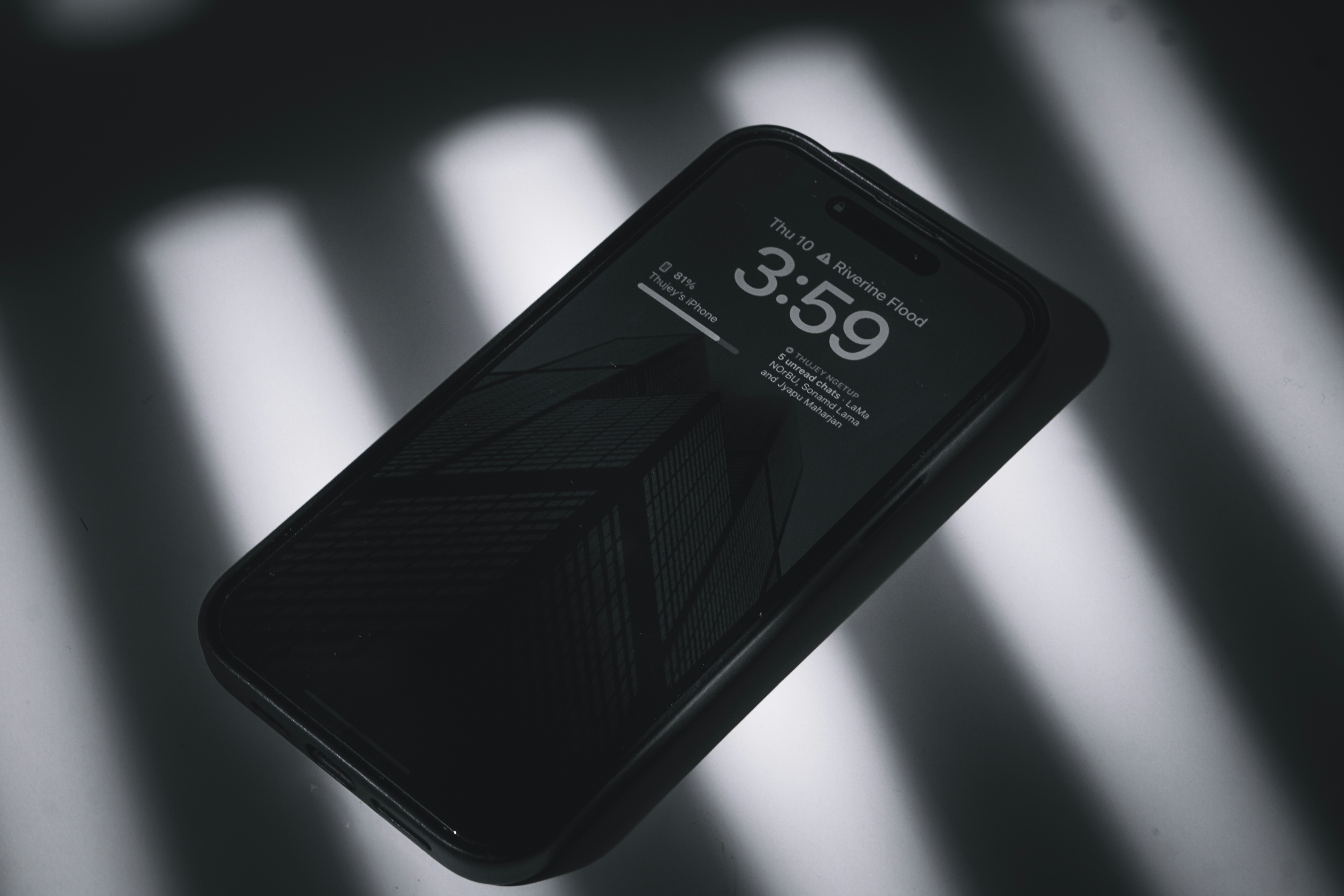 Black smartphone on a reflective surface