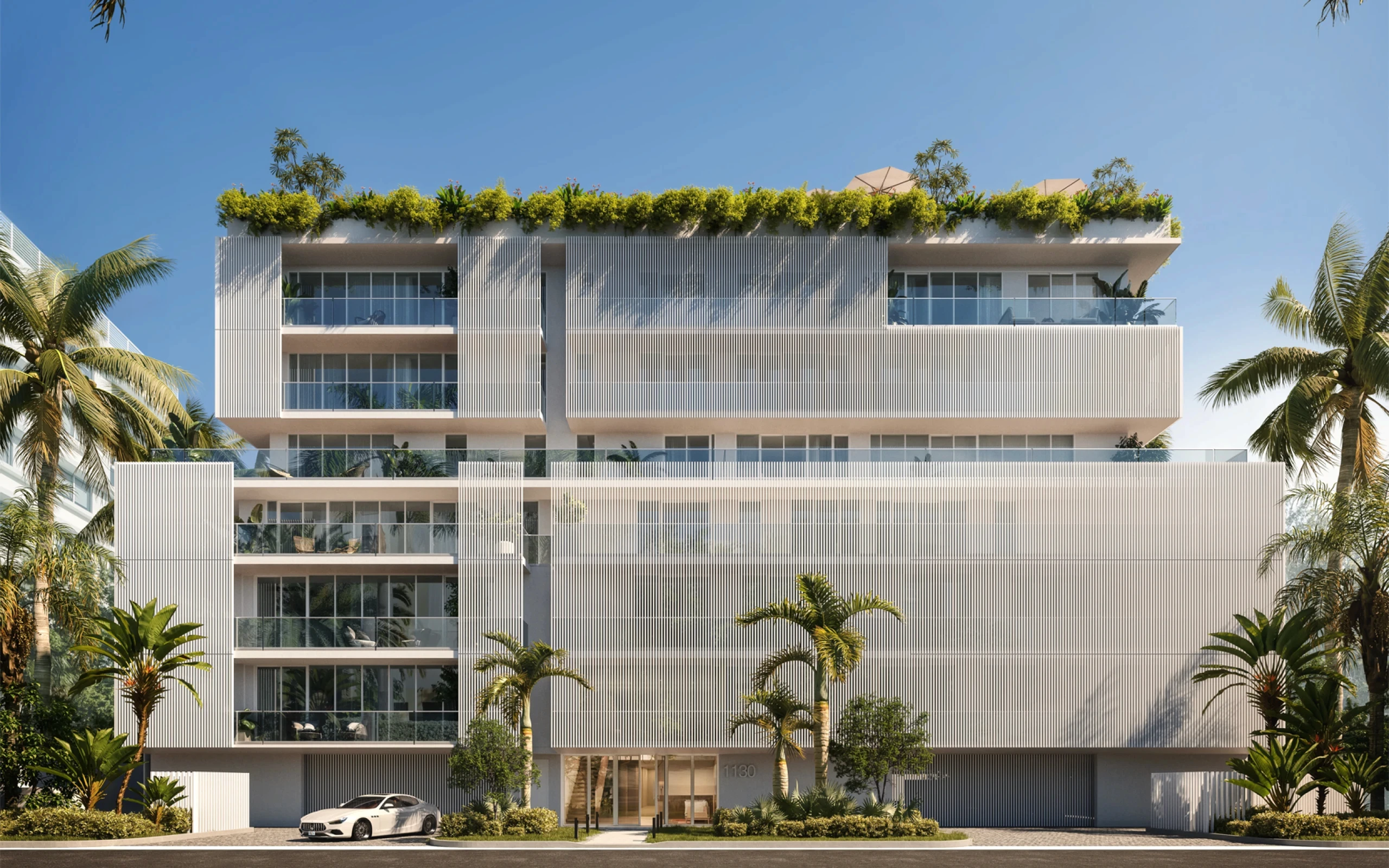 A modern building stands at the intersection of Palm Beach and Ocean Drive, showcasing contemporary architecture and design.