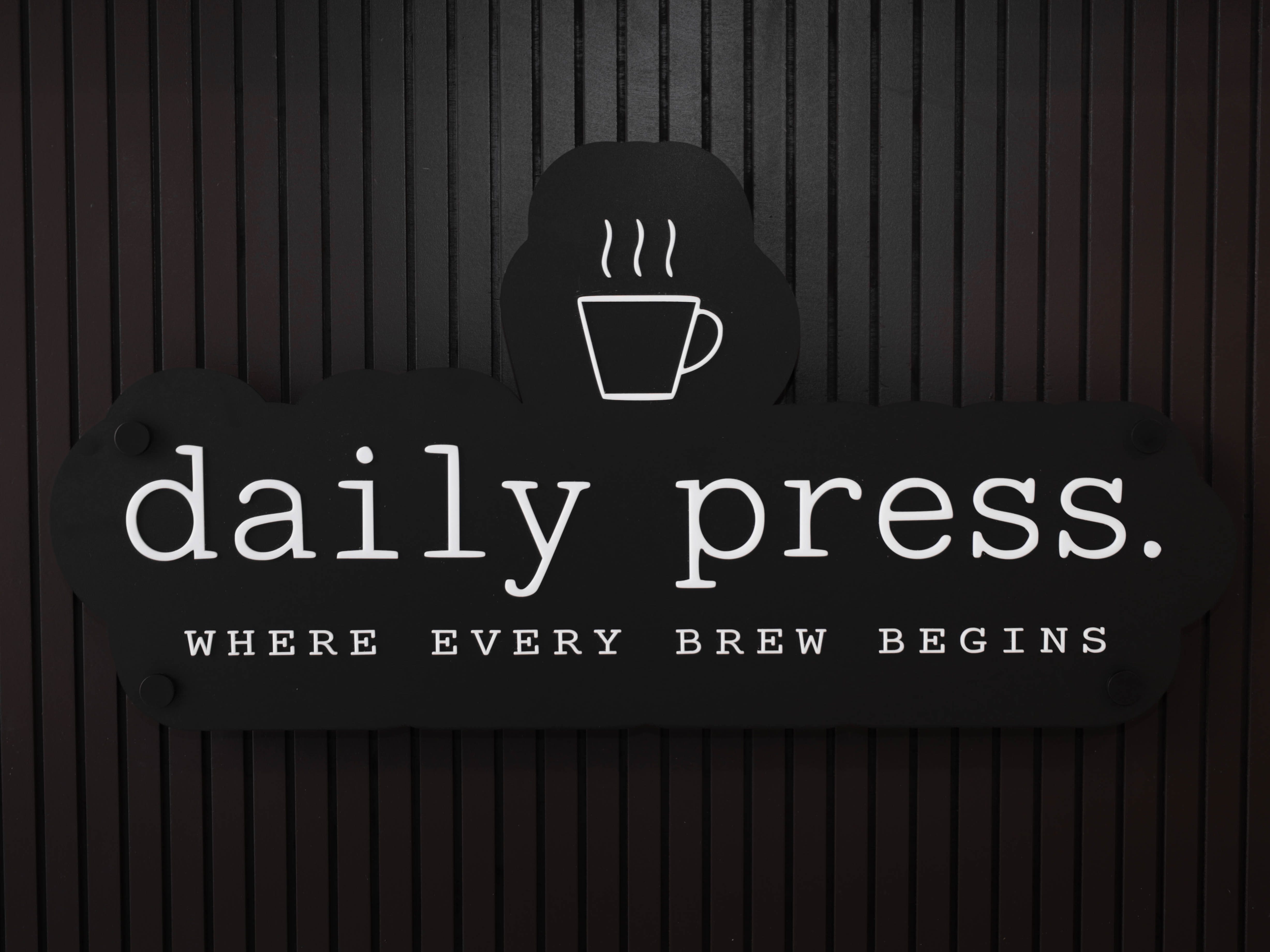 Close-up of Daily Press coffee cart signage