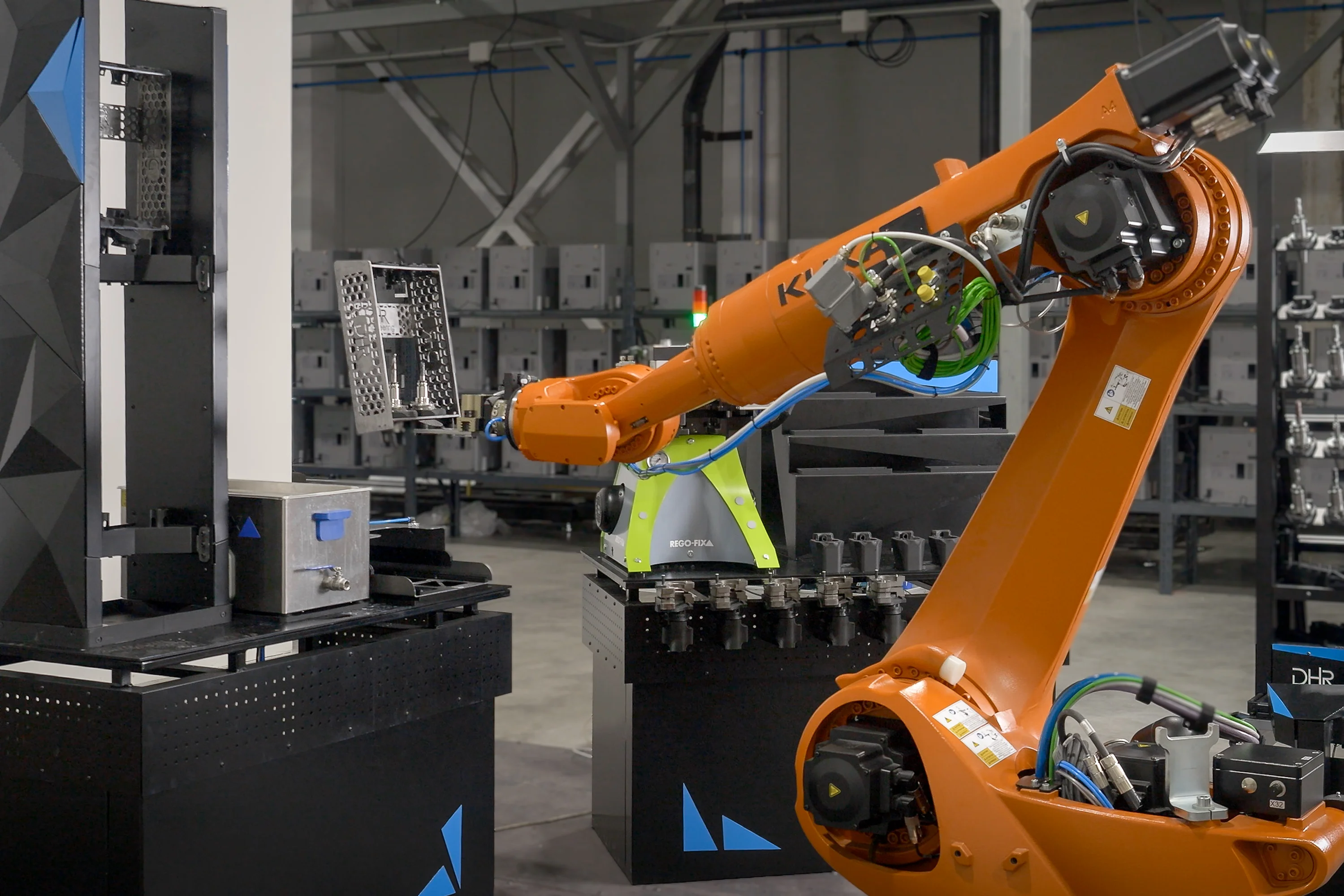 automated 3d print farm: A look into stacked bambu lab 3d printers with finished parts and a robot ready to unload the plates