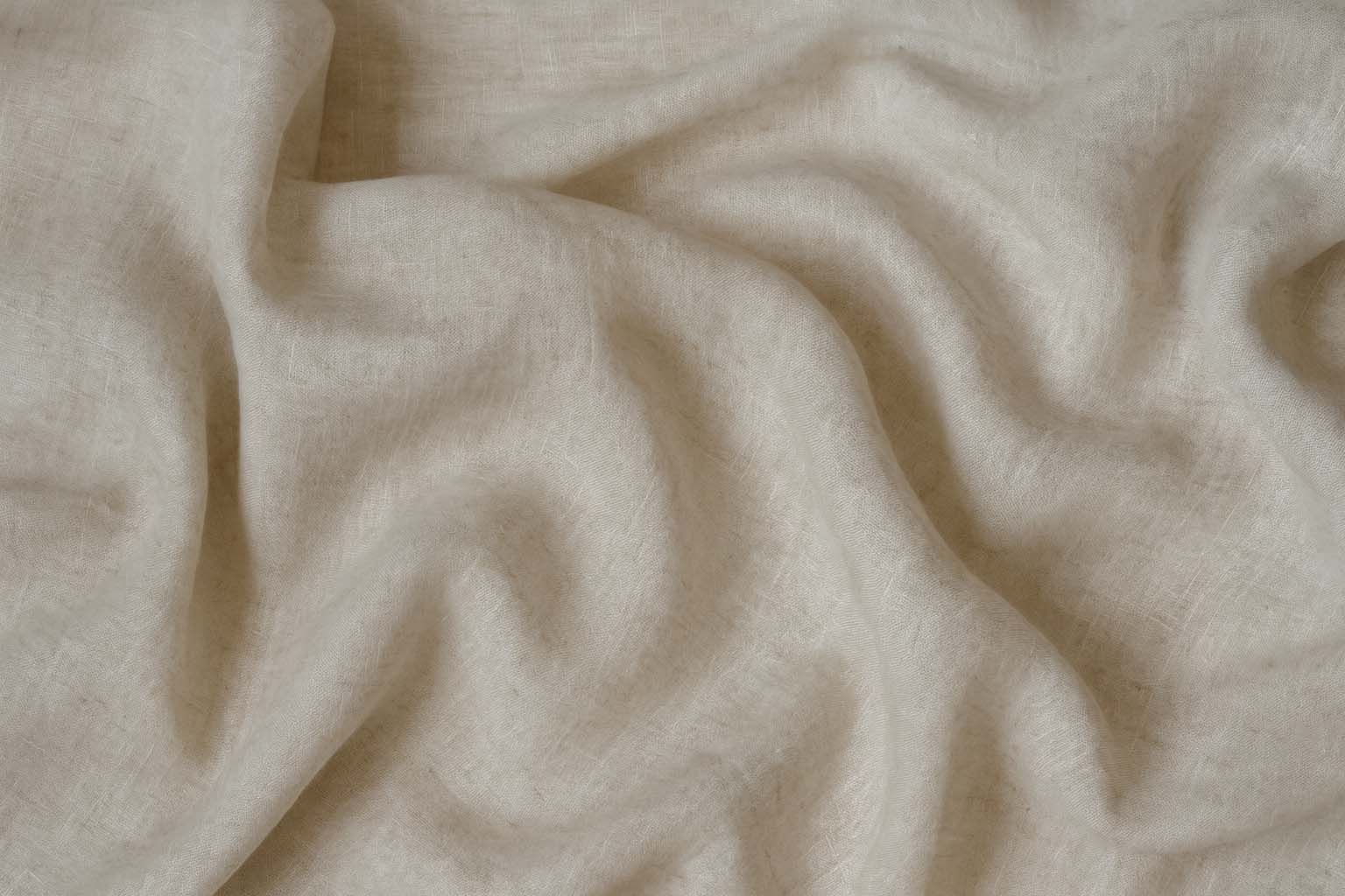 white textile on brown wooden table