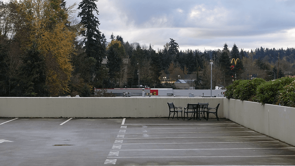 Outdoor table and chairs in T-Mobile campus parking lot, highlighting a disconnect between the company's core values and modern work needs.