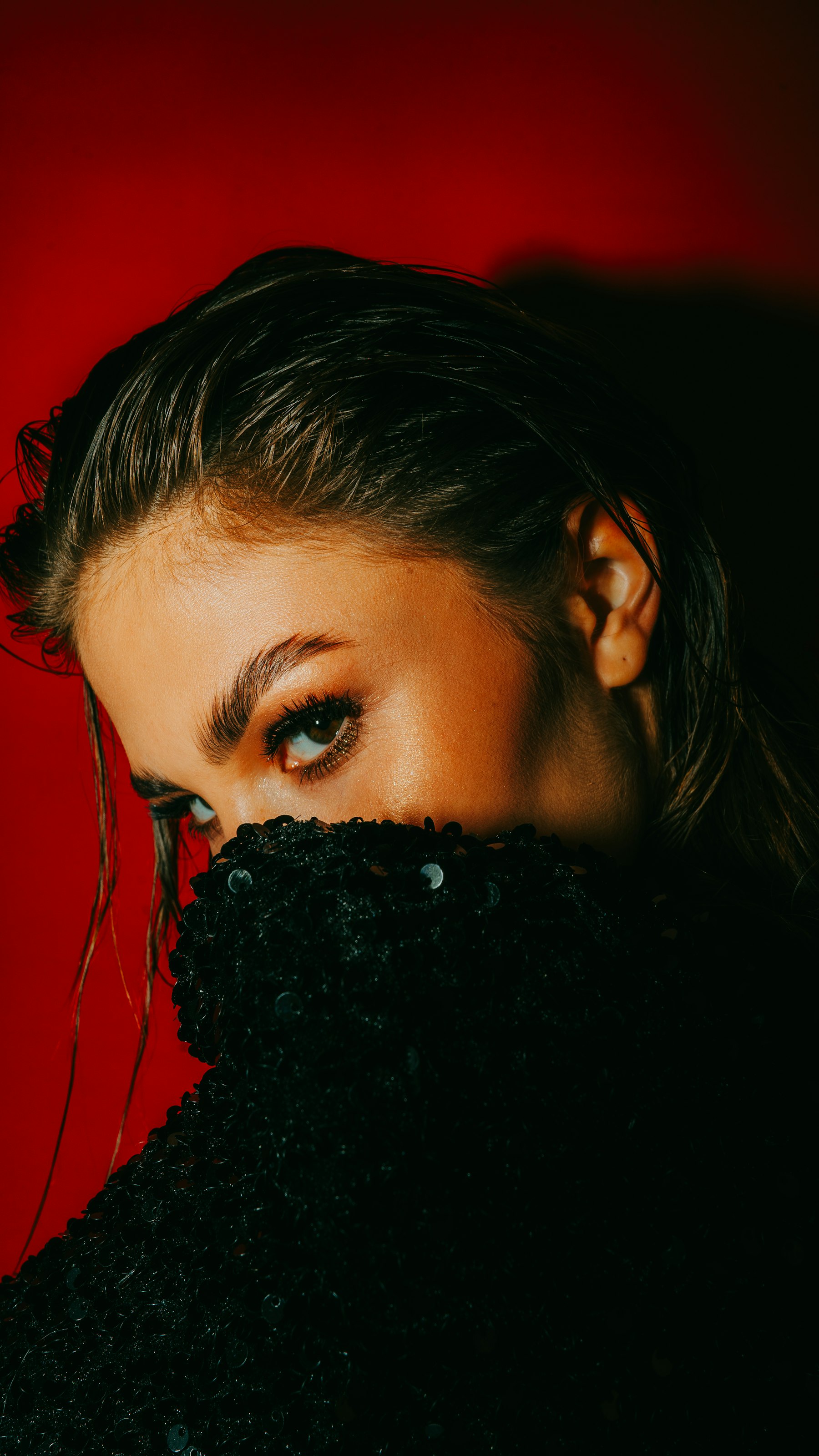 A close portrait, a black velvet coat hiding half the face