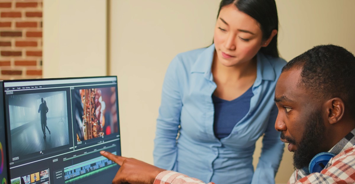 man and woman working in front of a computer