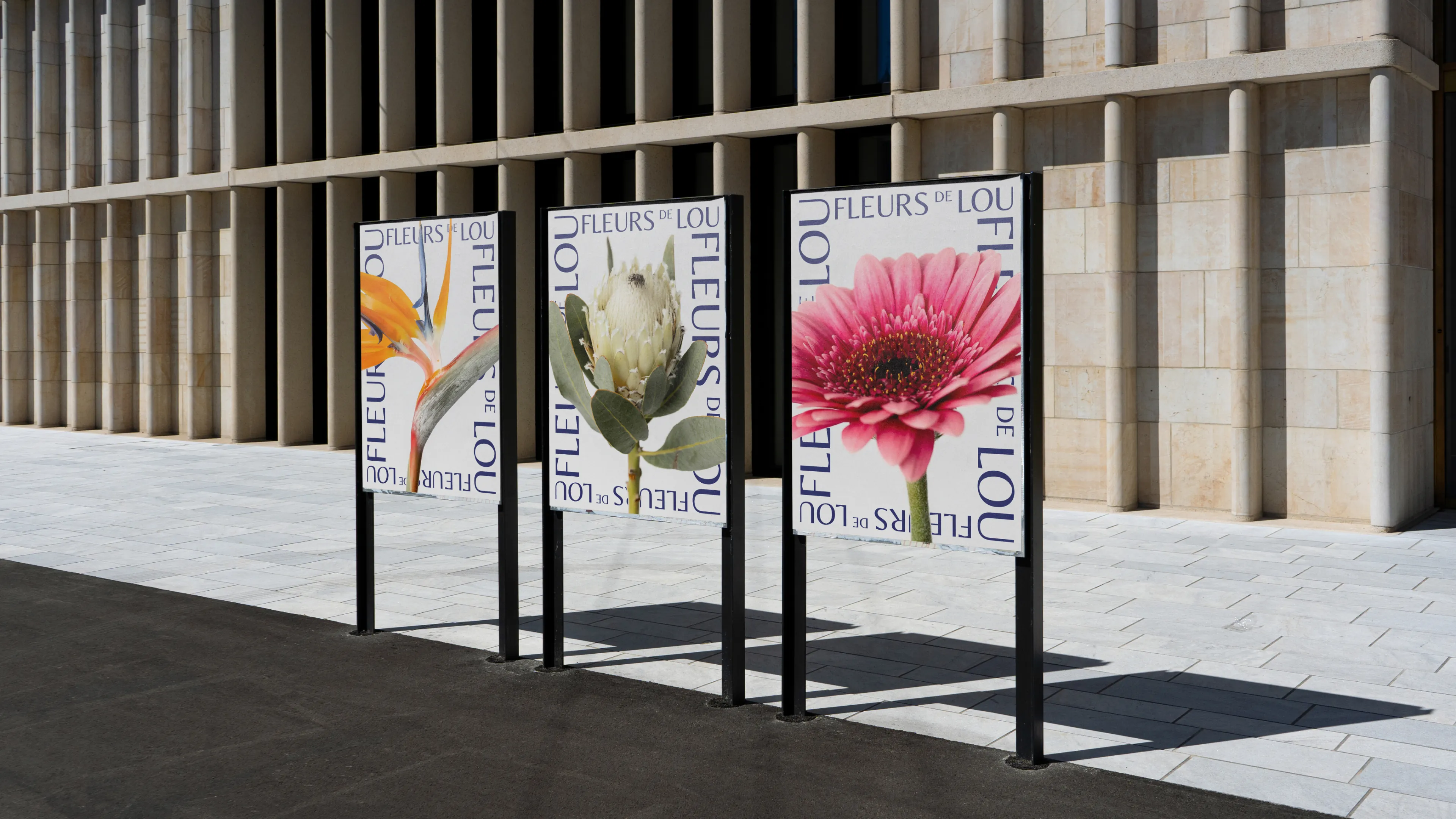 Streetside billboard with flyposters of the Batch.Works brand and illustrations