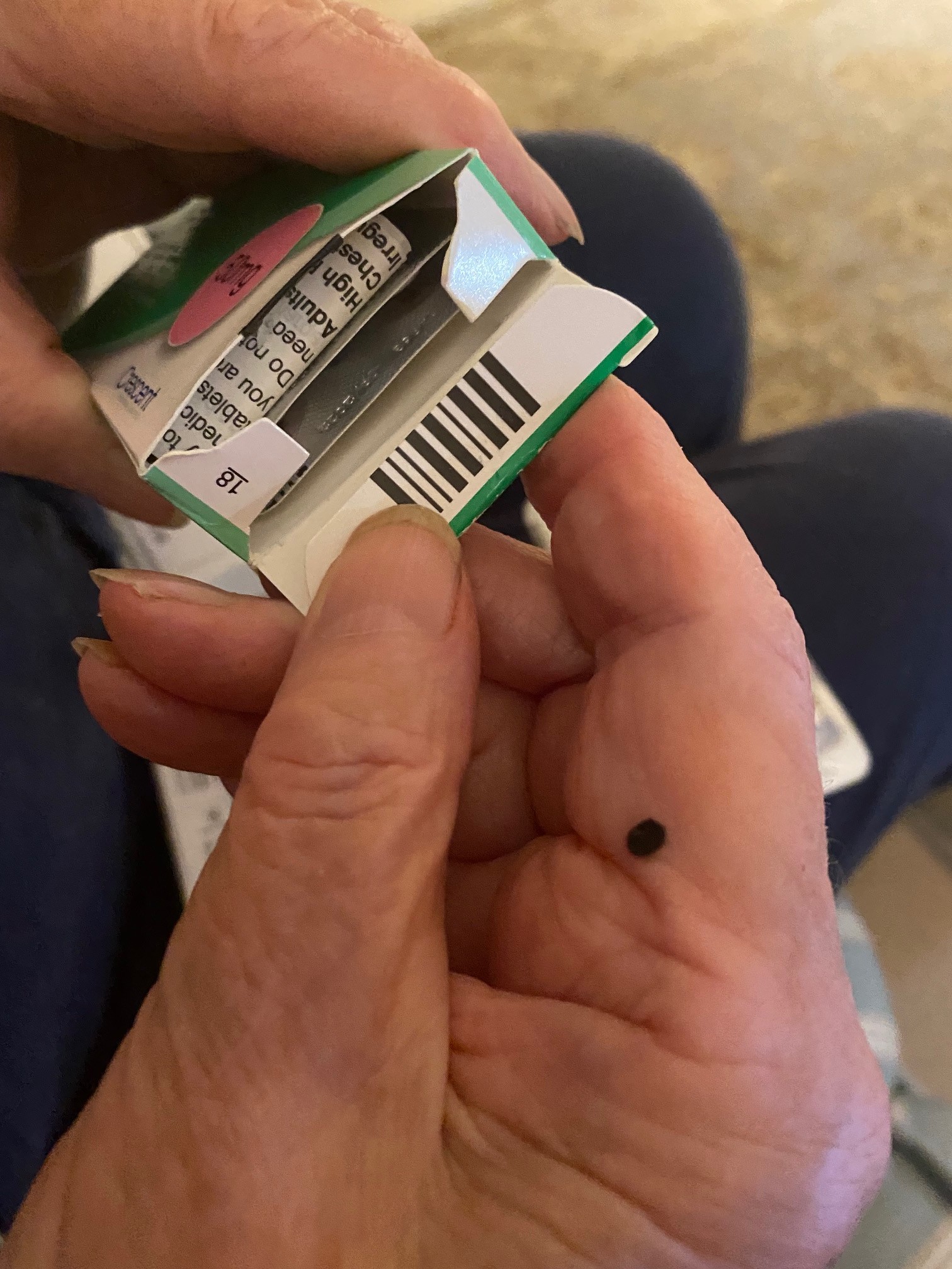 Elderly person opening pill packet 1.
