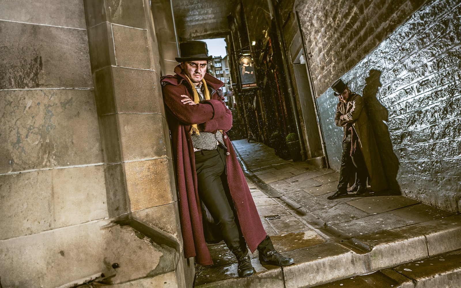 Tourists exploring the eerie atmosphere of the Edinburgh Dungeon, a popular attraction in Edinburgh, Scotland