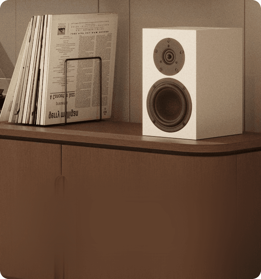 White speaker and records on a shelf