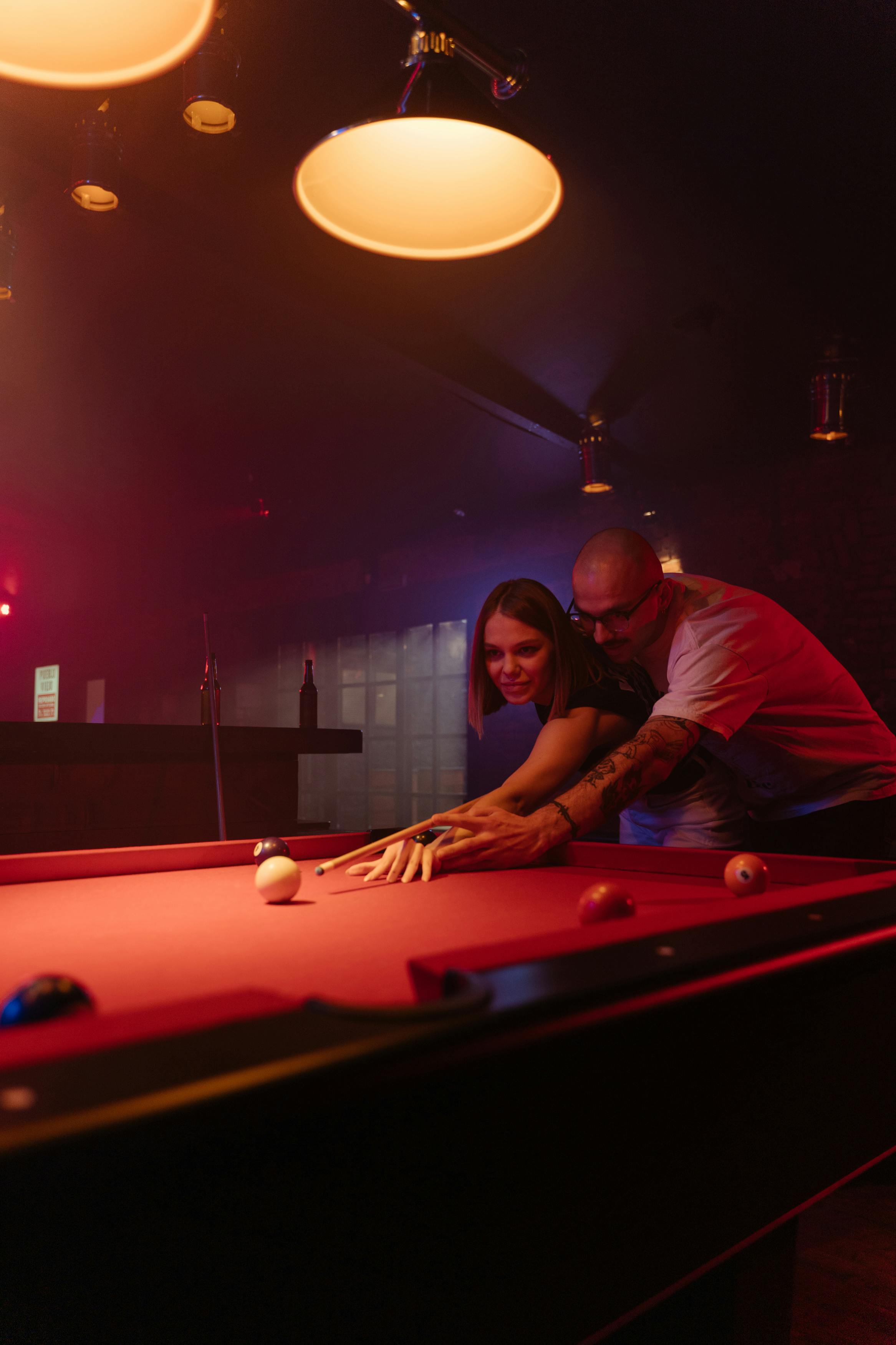 Close-up of lush, dark green leaves, some glossy and wet, against a muted background.