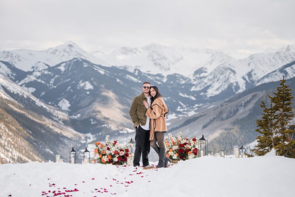 Couple standing together after a proposal in the snow
