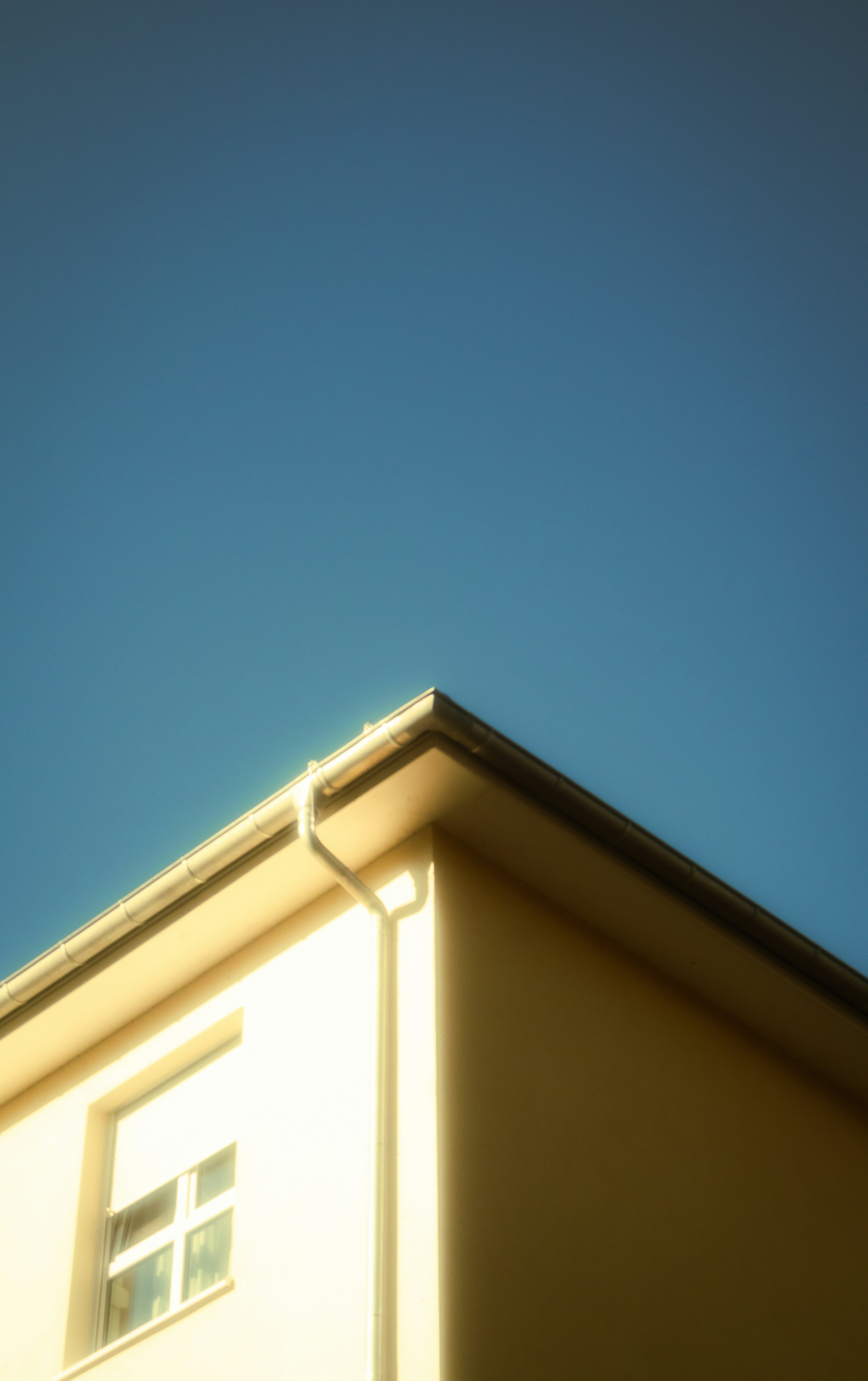 Corner of a building against a clear blue sky