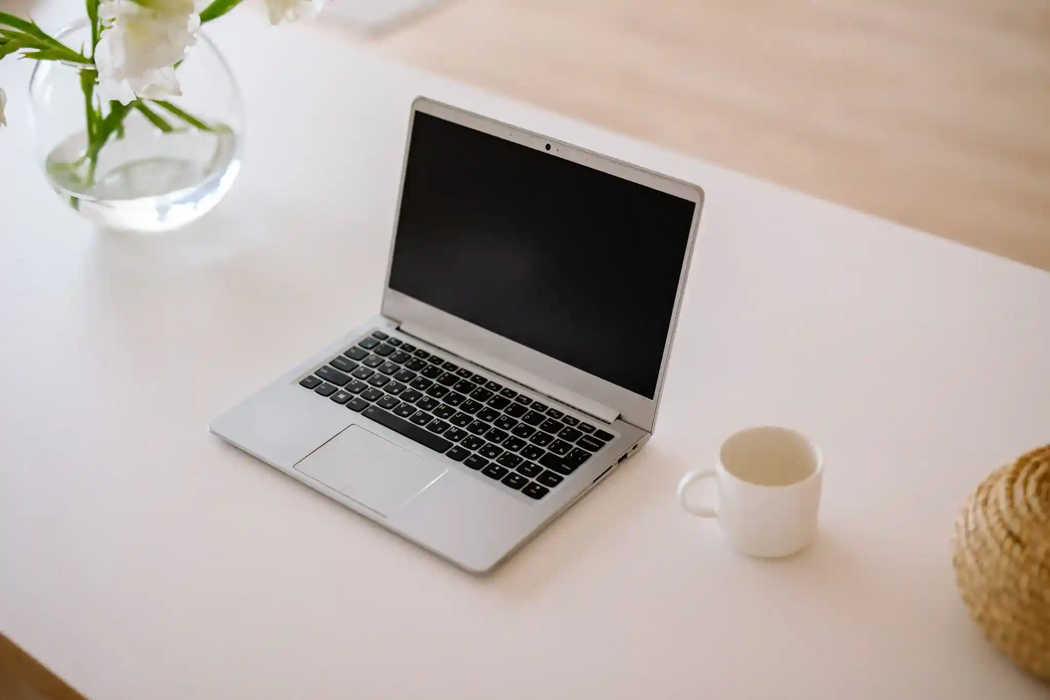 laptop at a desk with a smartphone, representing professional web design services.
