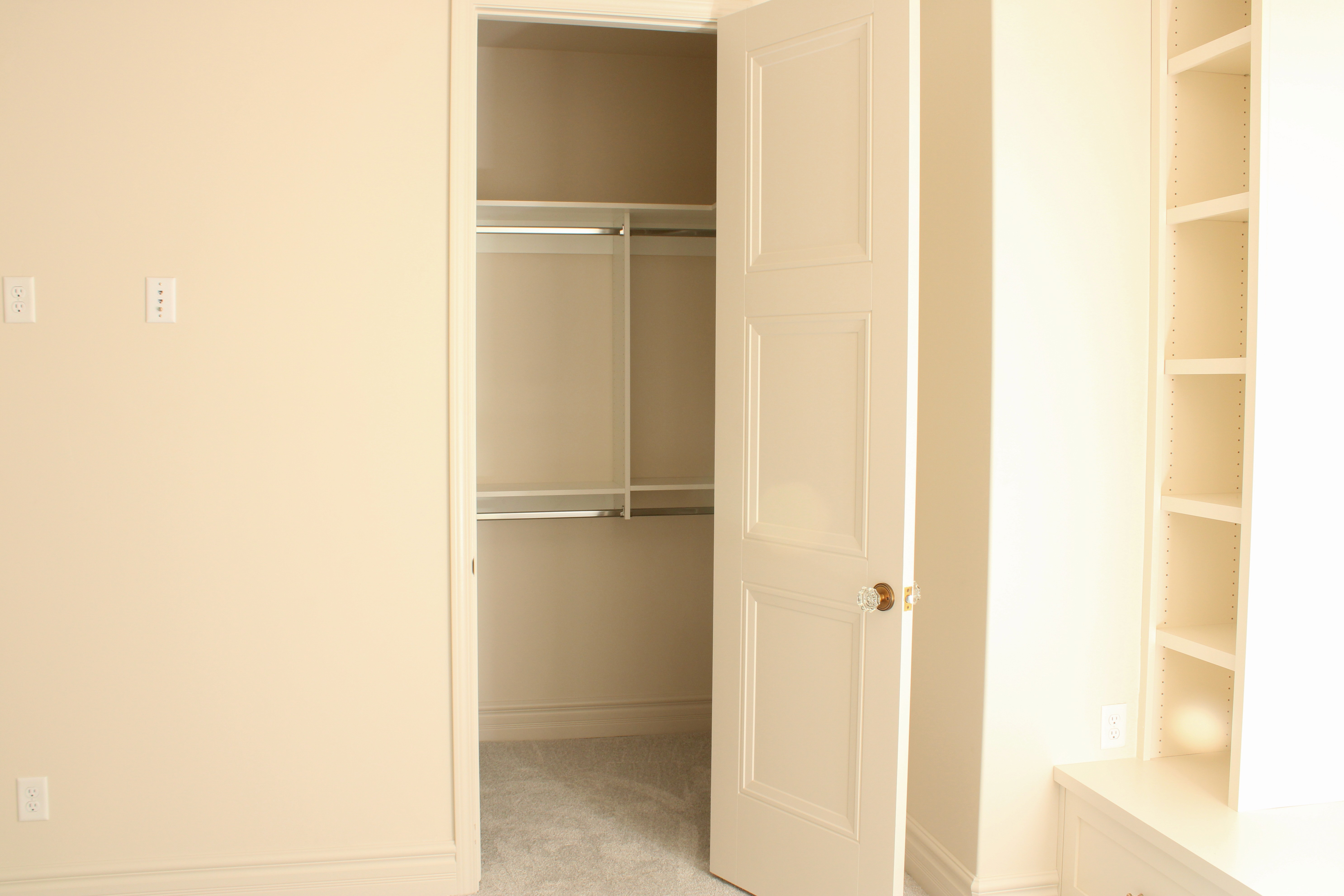 Bedroom with a full closet, an open door, and a unique custom crystal door knob in a Southern Utah home.