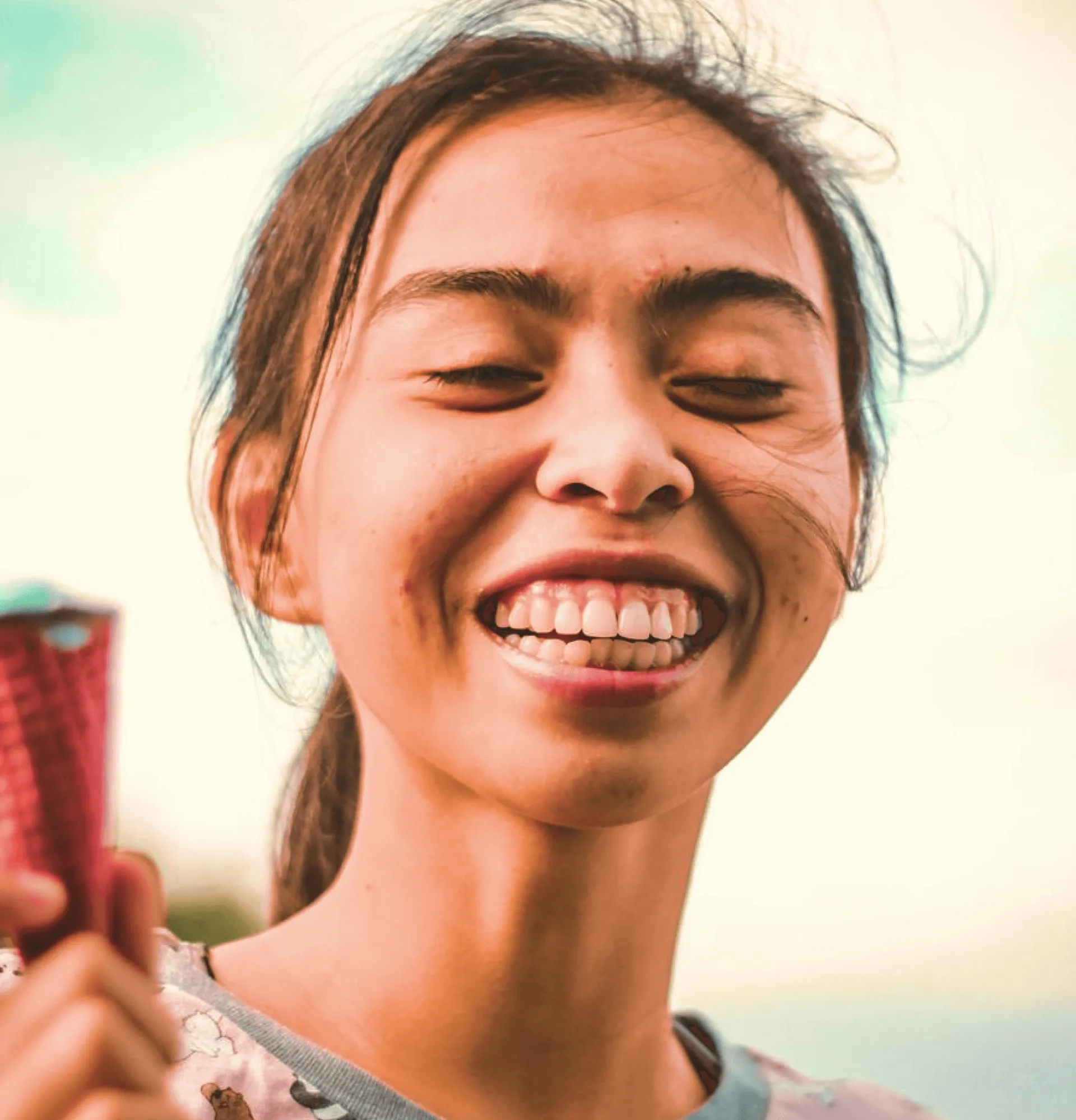 a young woman smiling showing teeth