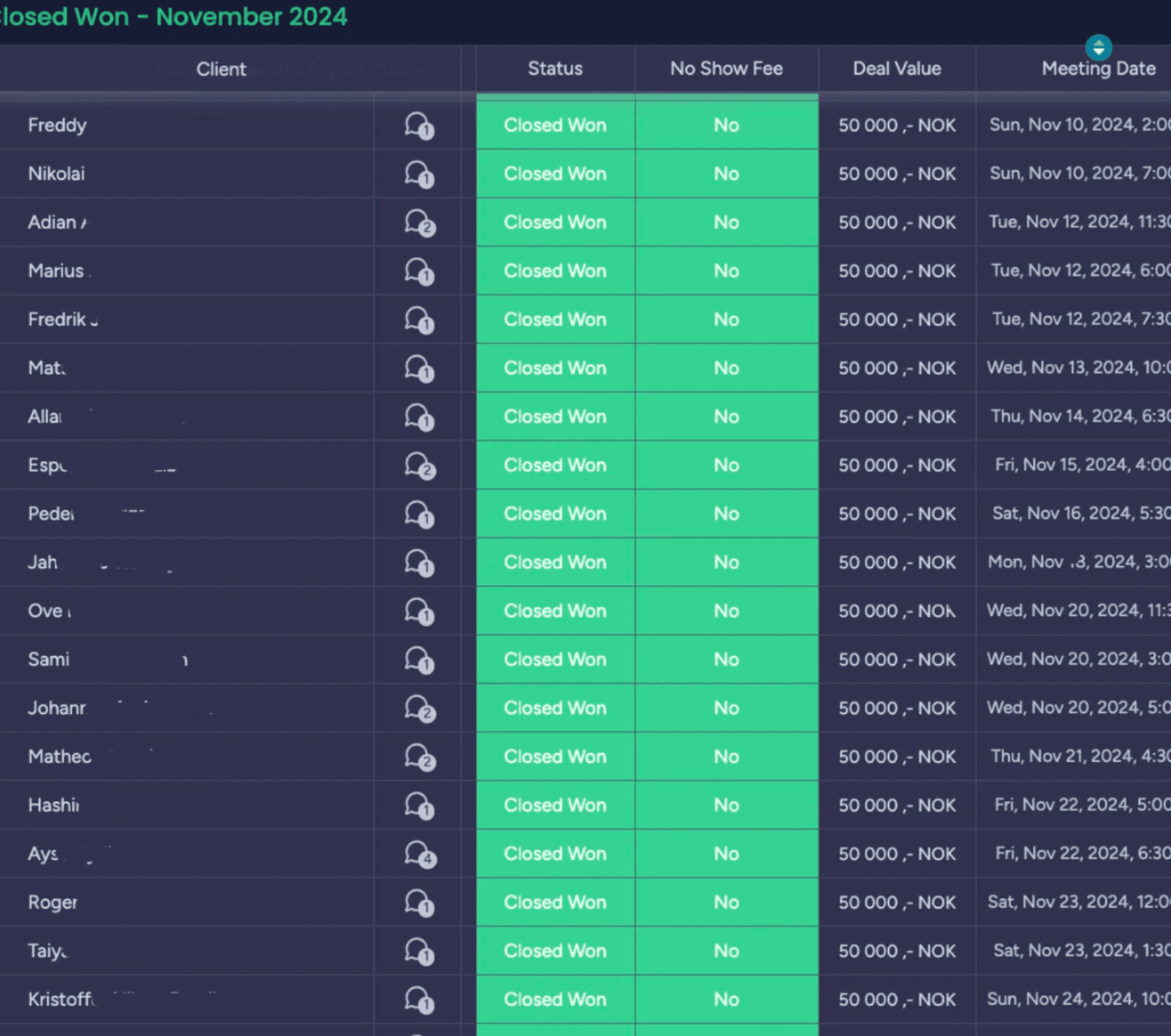 A young person with curly hair smiles at the camera while sitting in front of a laptop against a dark background.