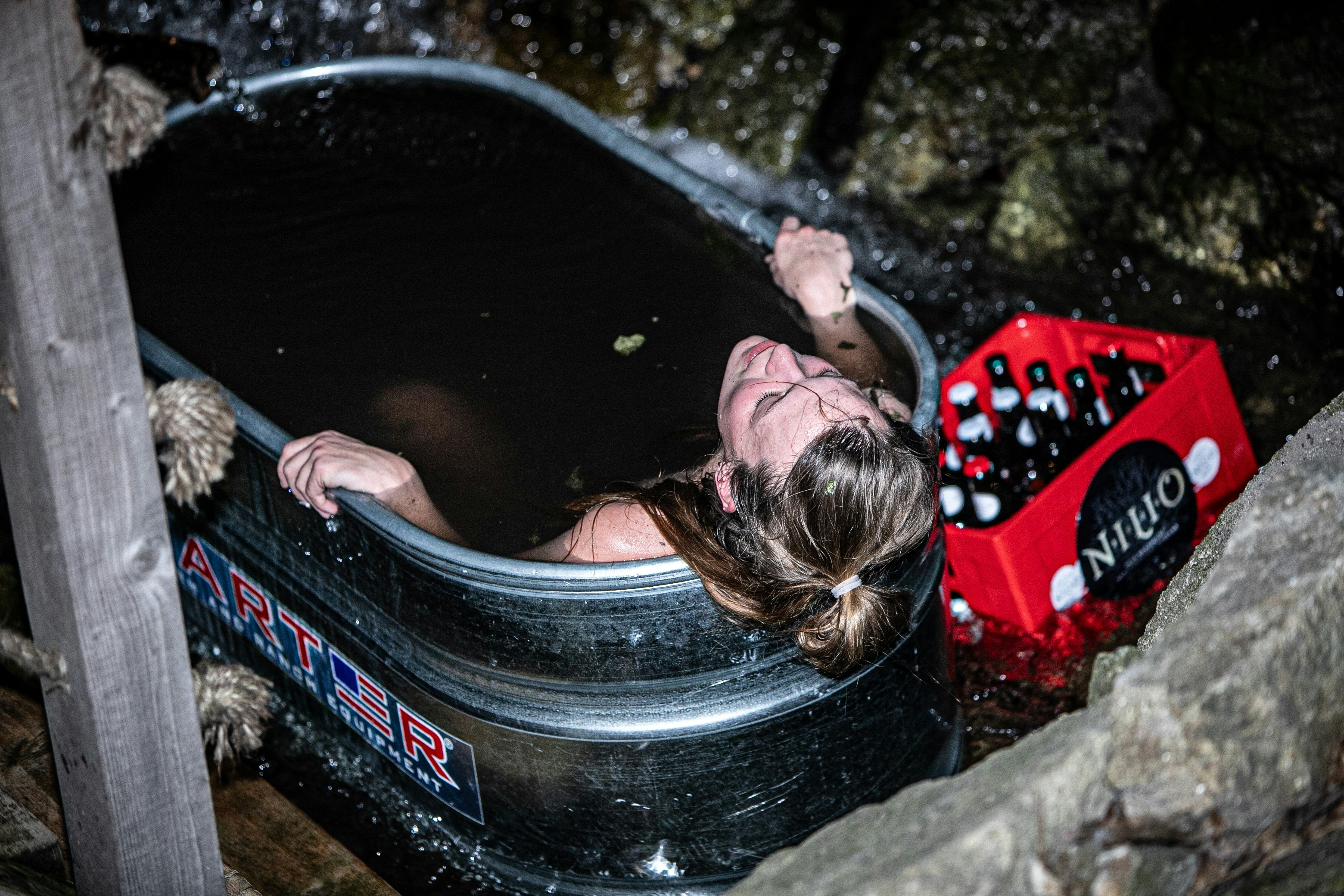 a woman taking a bath in a hot tub